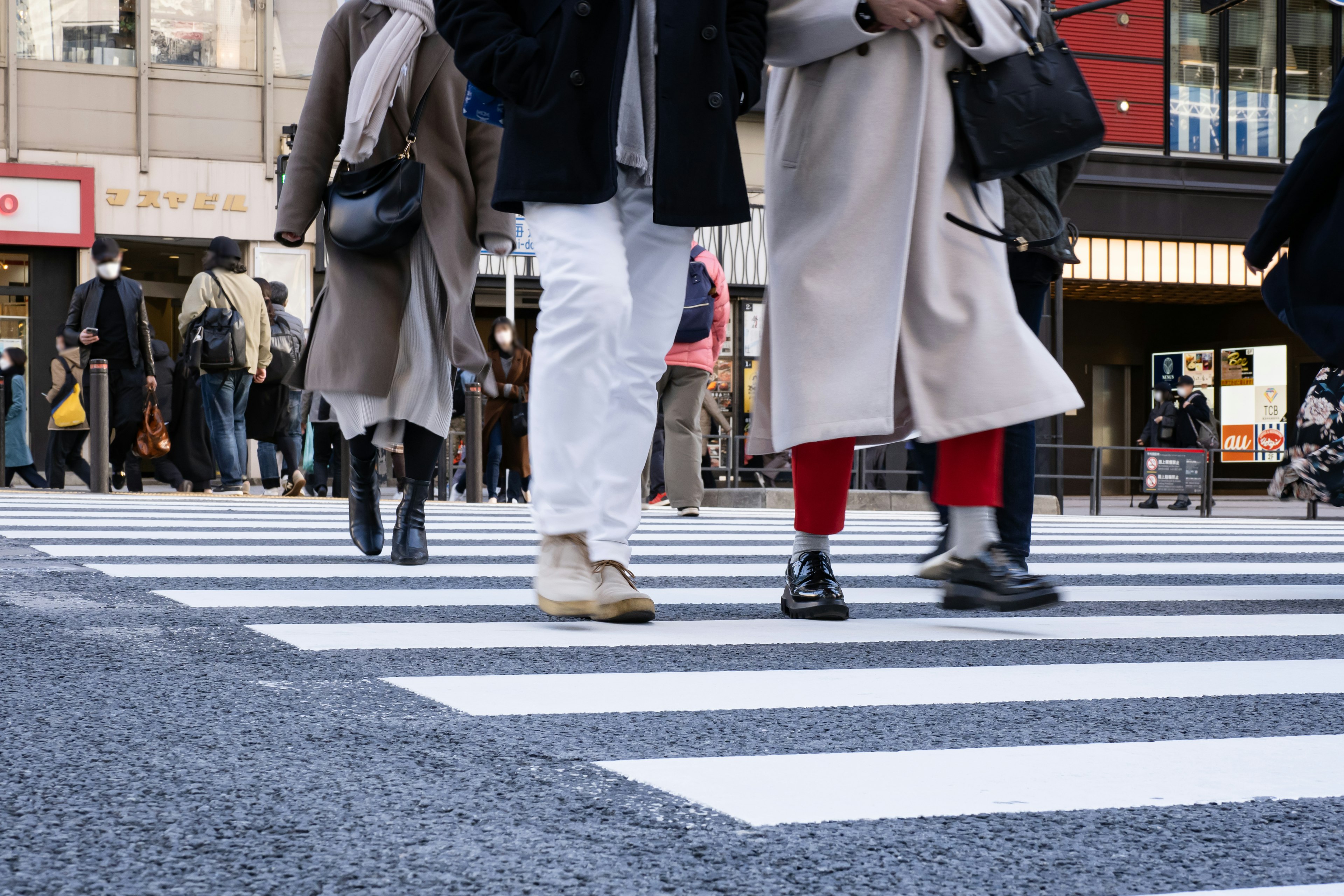 Pedestrians crossing a zebra crossing in an urban setting