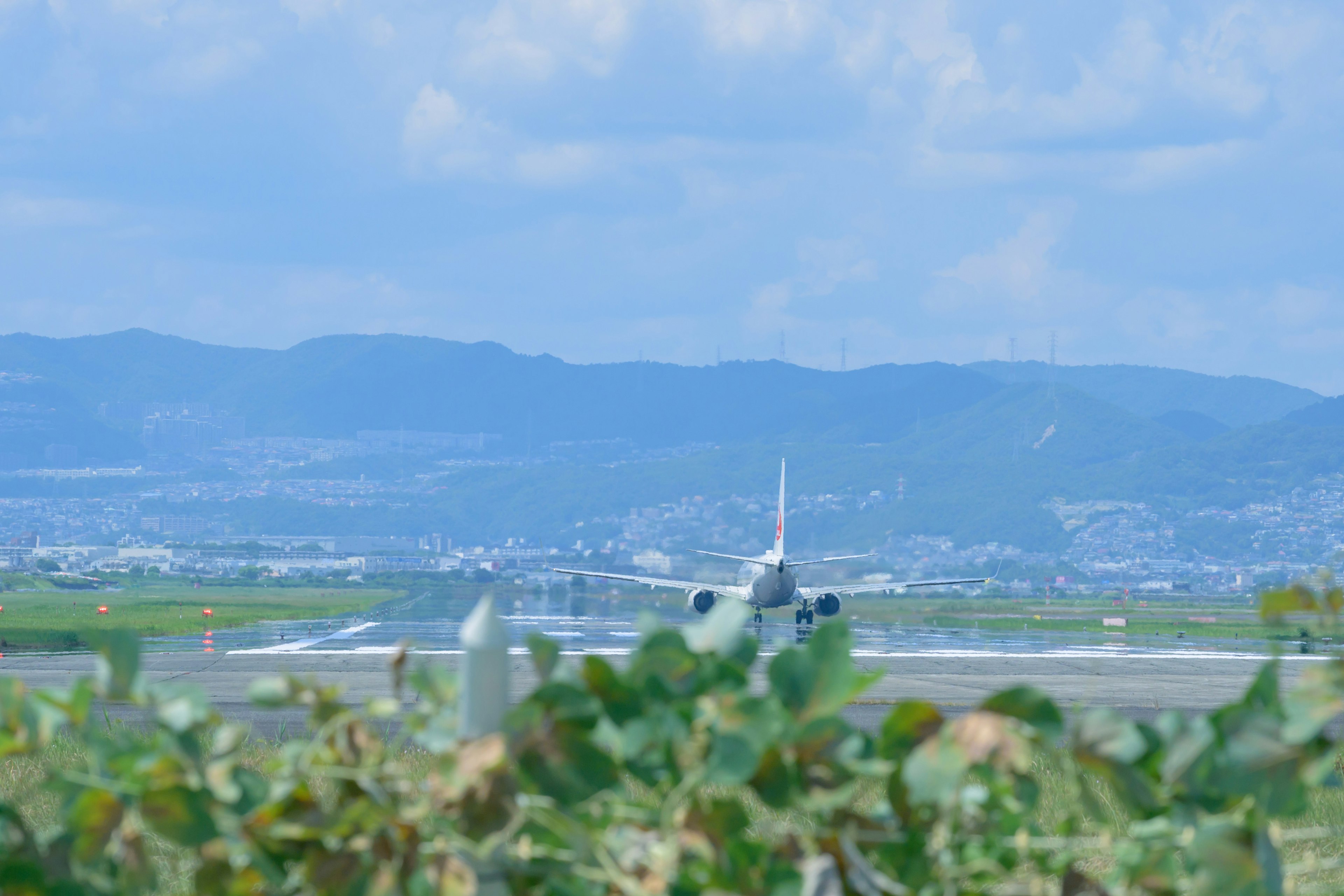 Airplane taking off at an airport with a blue sky