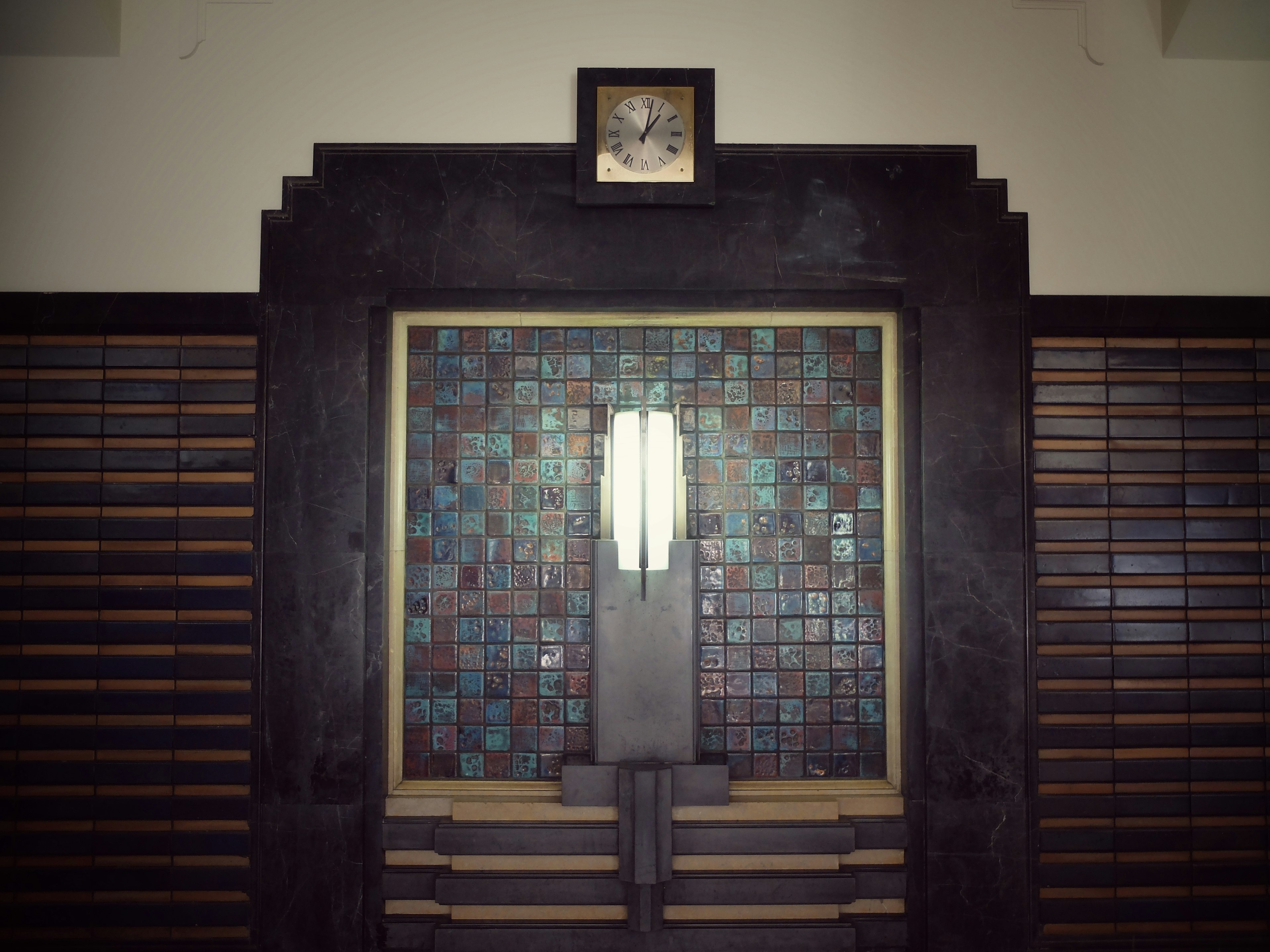 Art Deco style door with decorative tiles and unique lighting