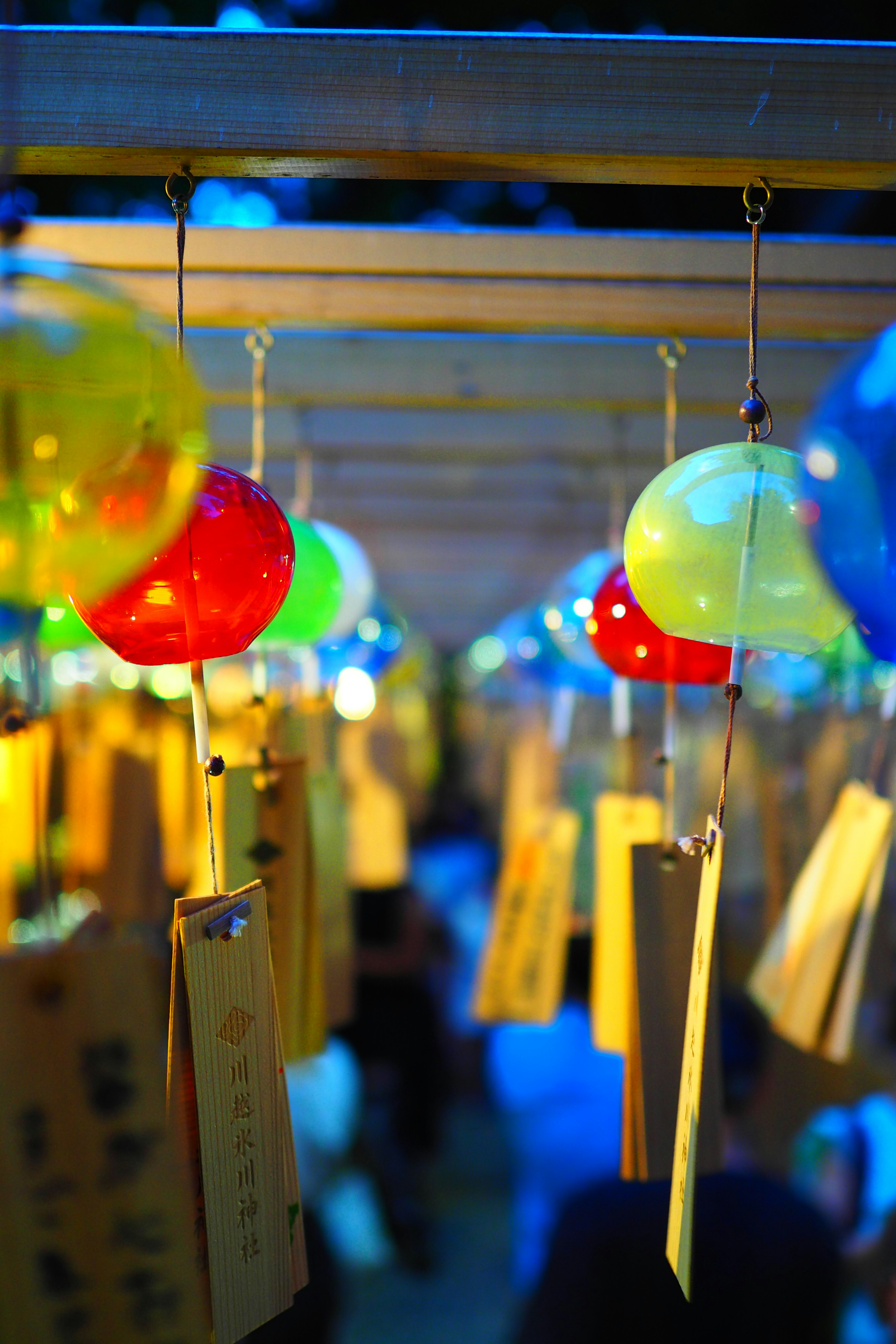 Colorful wind chimes hanging in a night scene