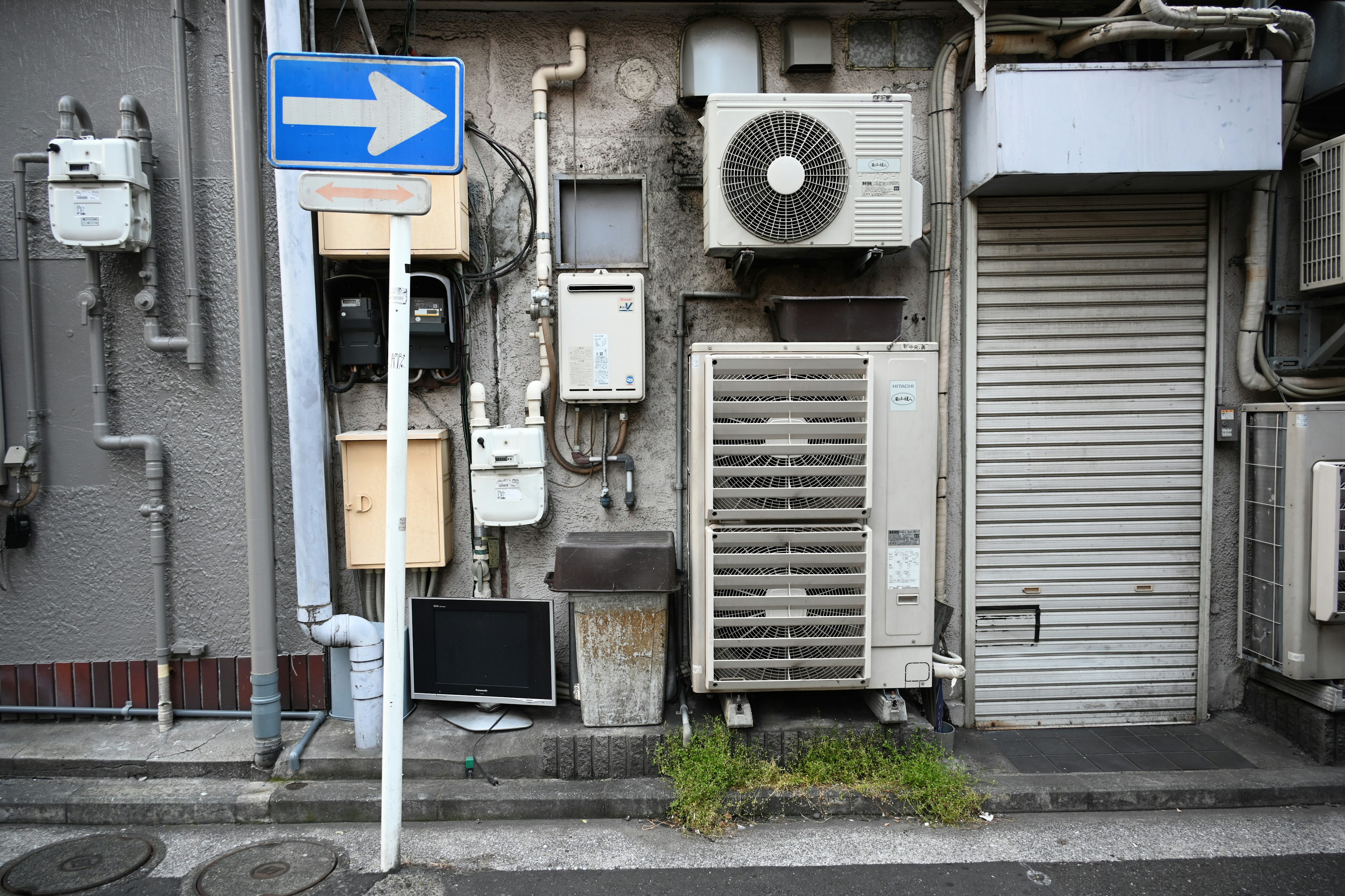 Urban scene with wall-mounted air conditioning units and electrical meters