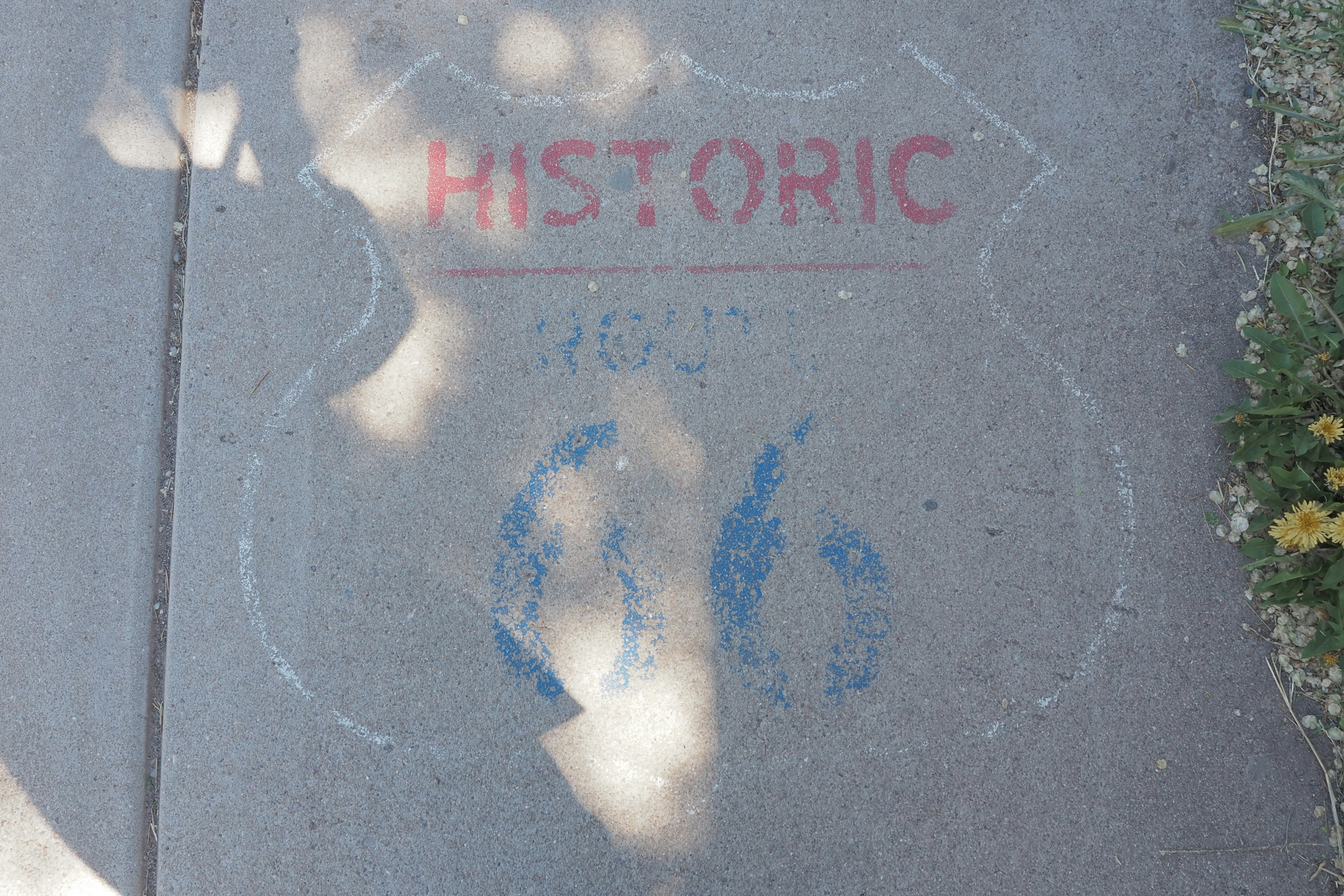 Historic Route 66 marker painted on sidewalk