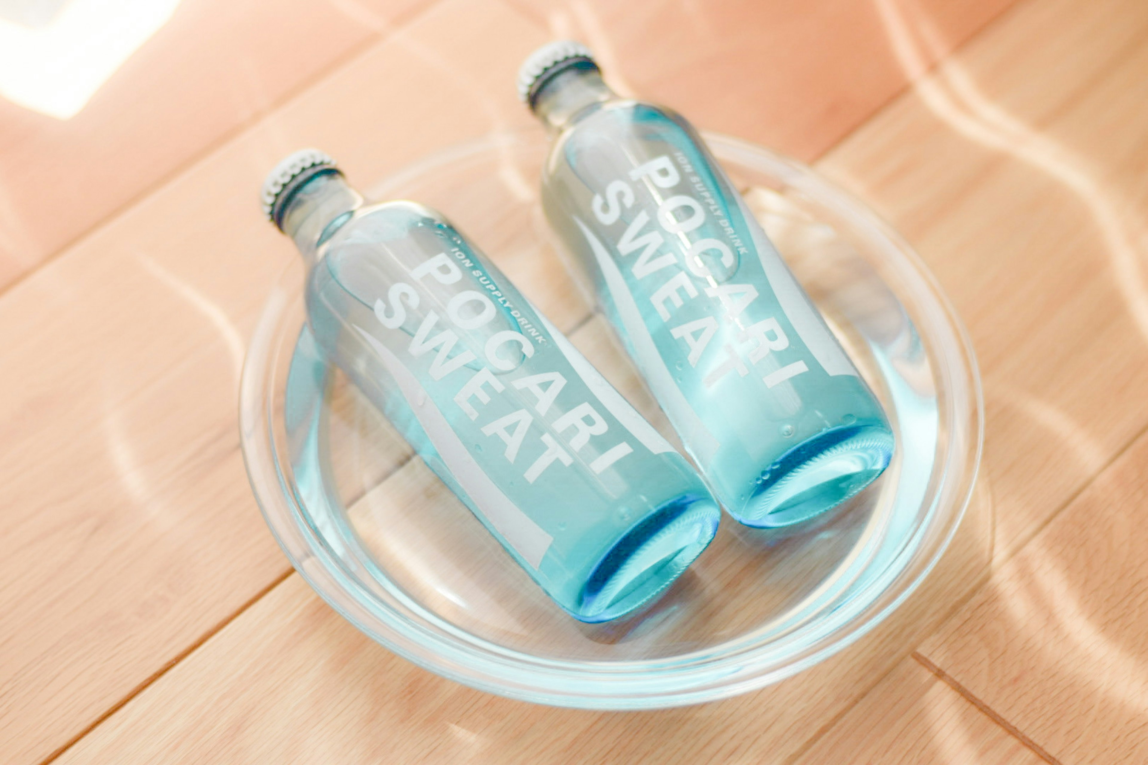 Two bottles of Pocari Sweat in a clear dish