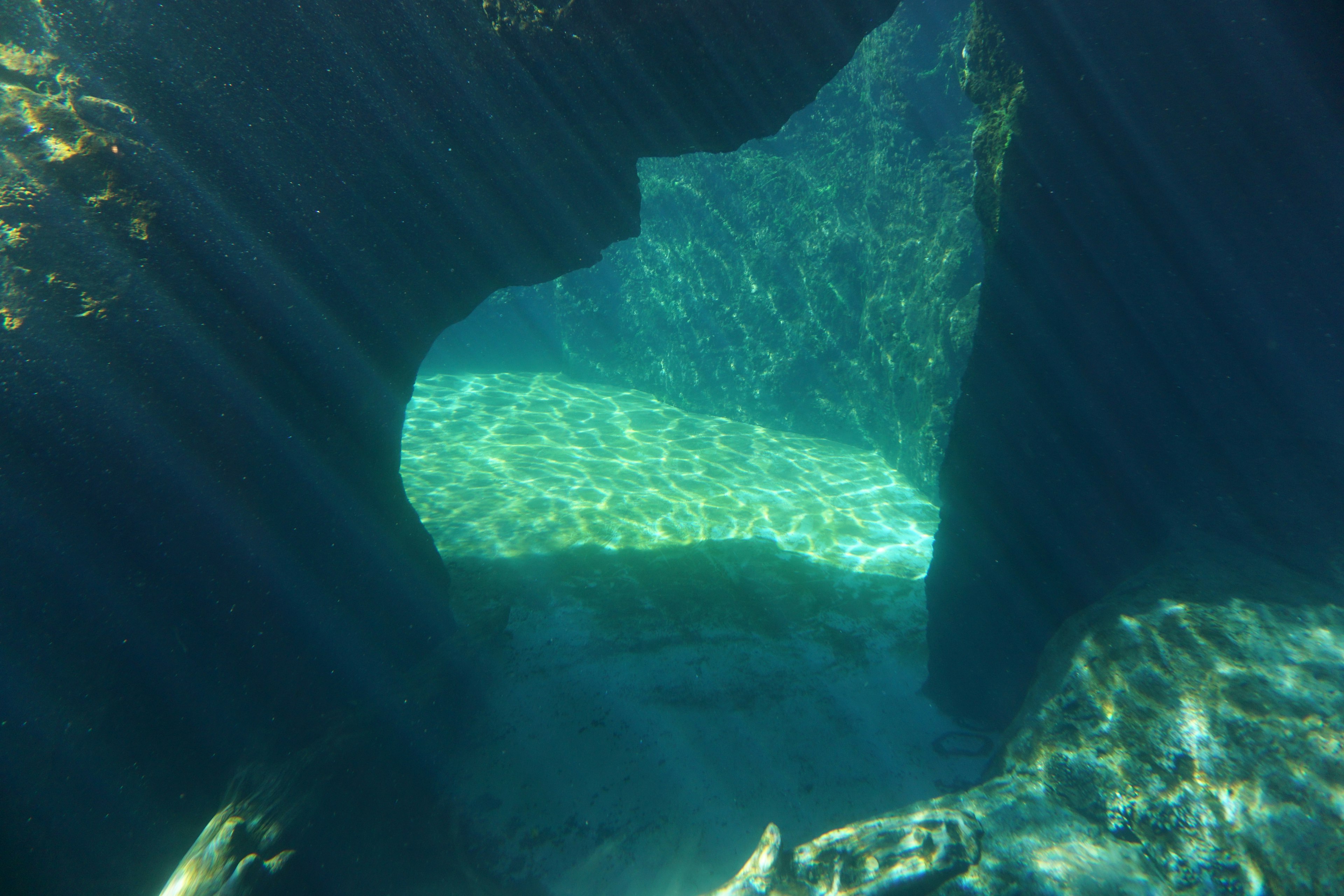 Underwater cave-like structure with light rays