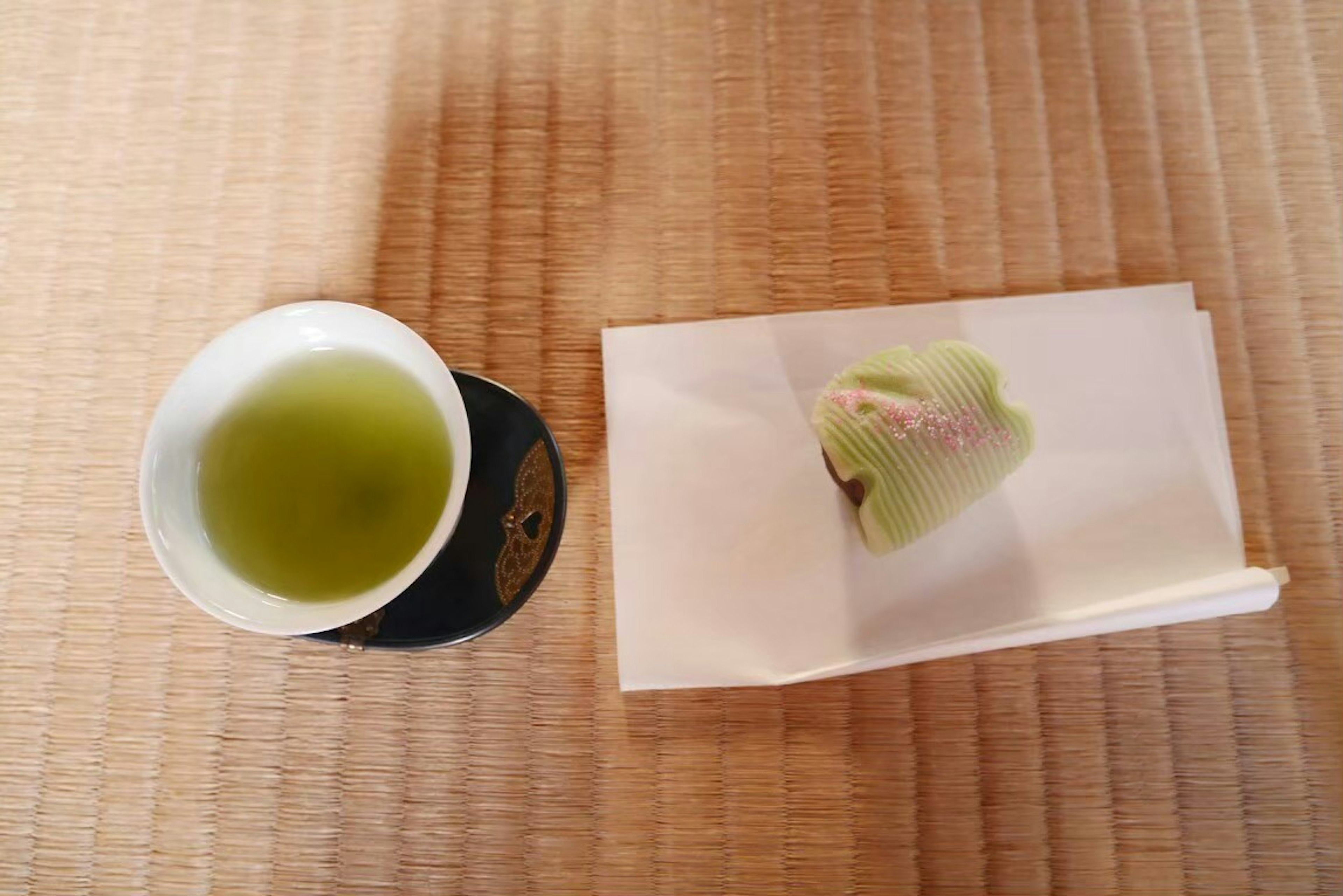 Green tea and Japanese sweets on a tatami mat table