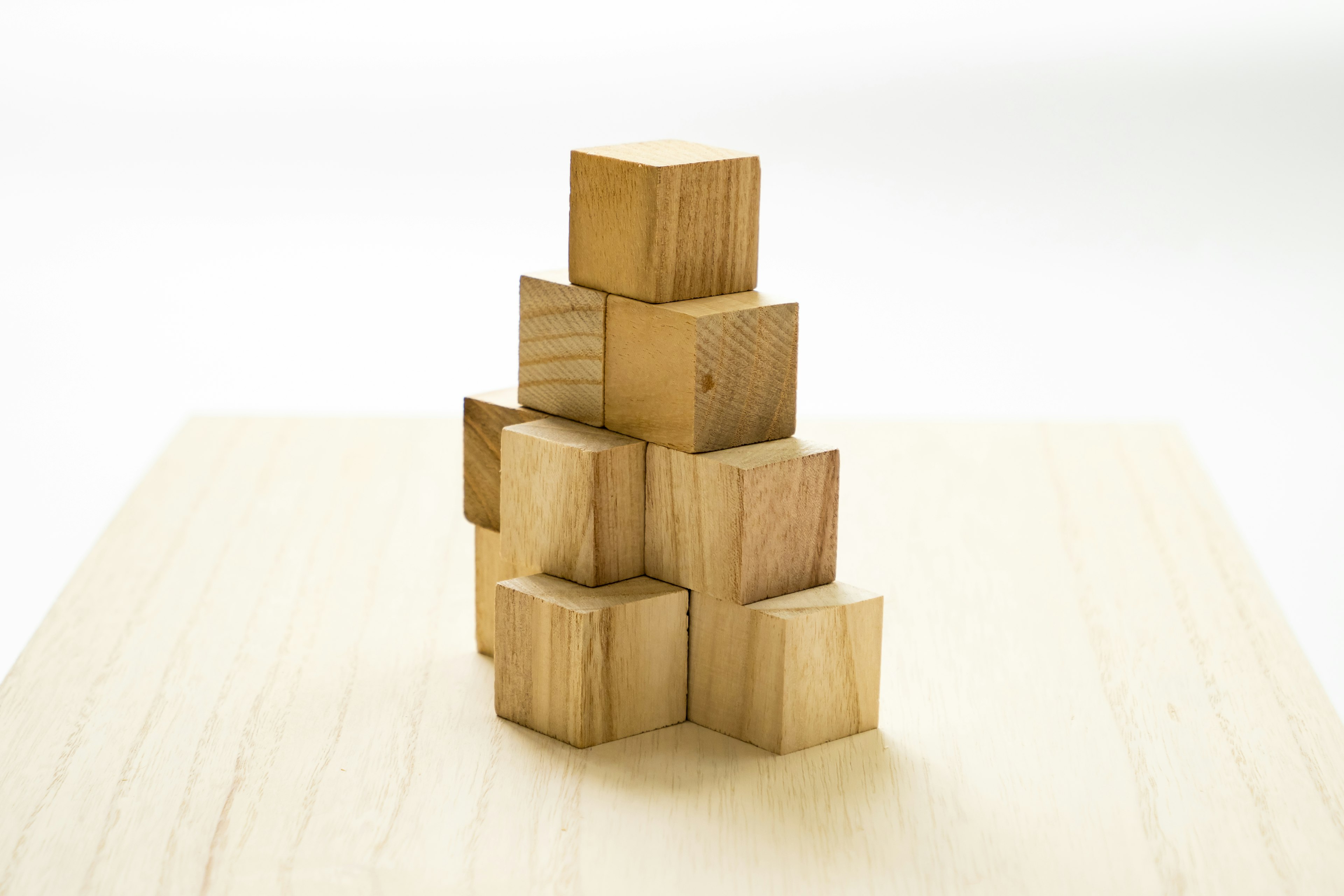 Photo of stacked wooden cubes forming a pyramid shape