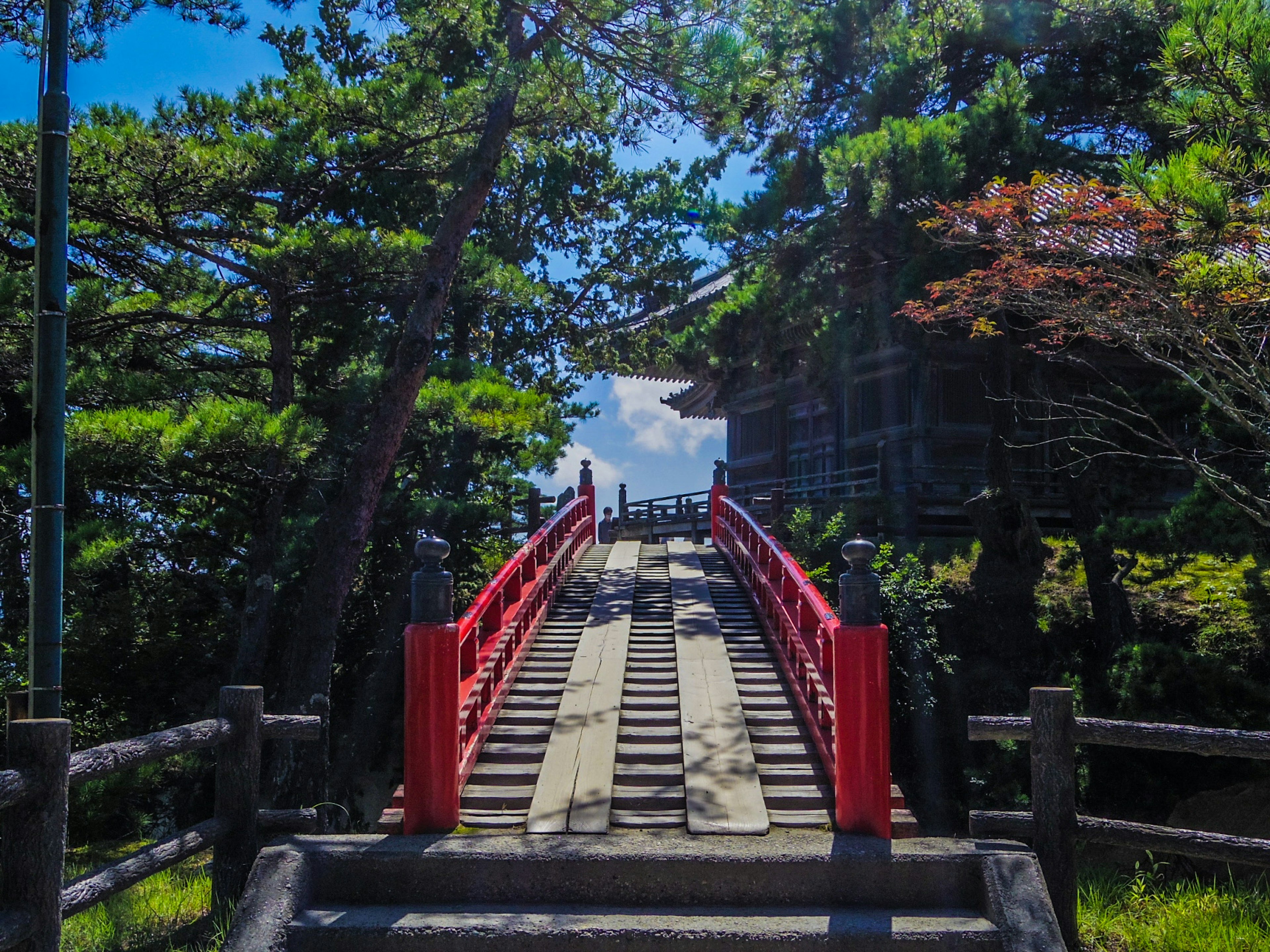 ทิวทัศน์ที่สวยงามมีสะพานสีแดงและต้นไม้เขียวขจี