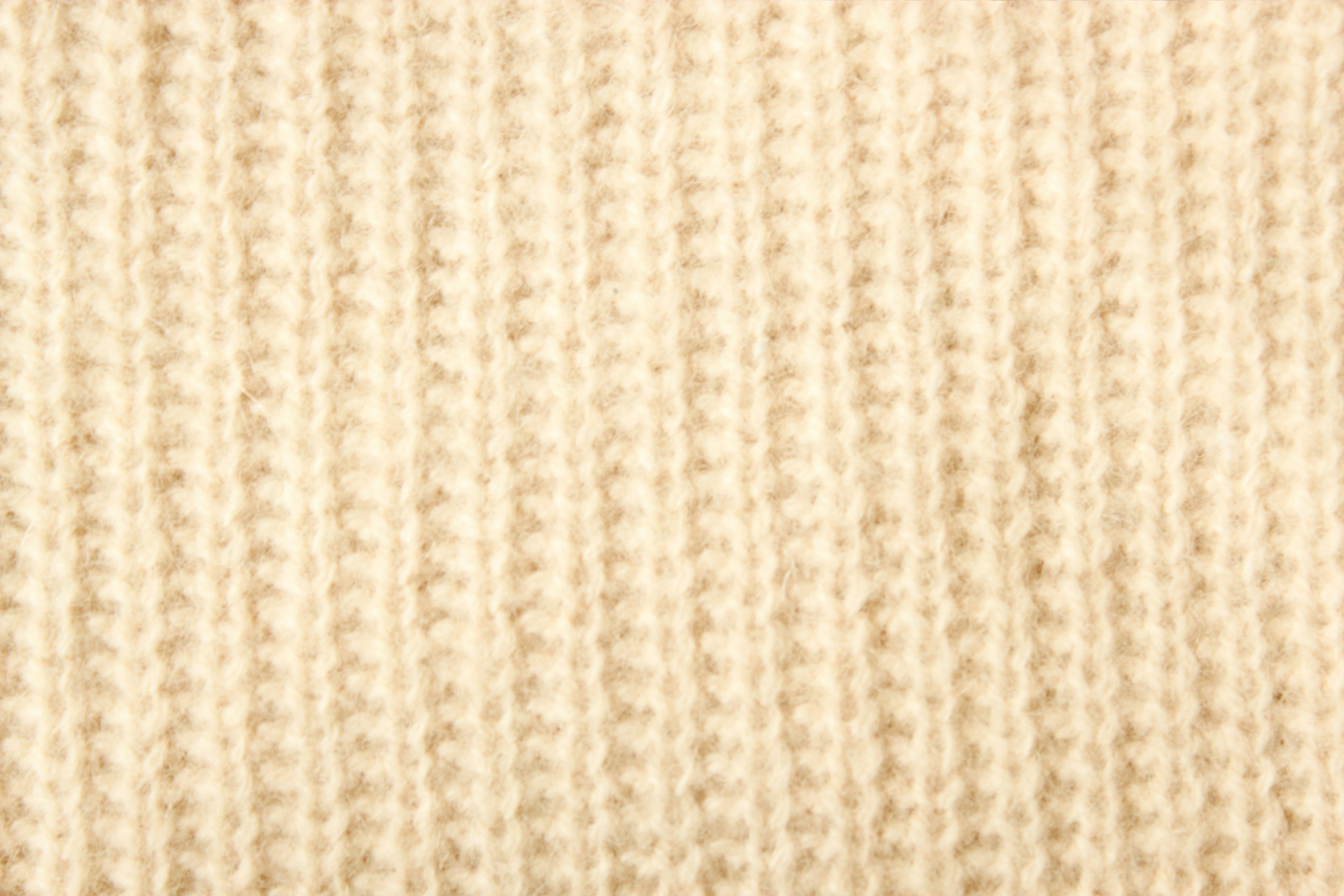 Textura de tela de punto color crema con líneas verticales