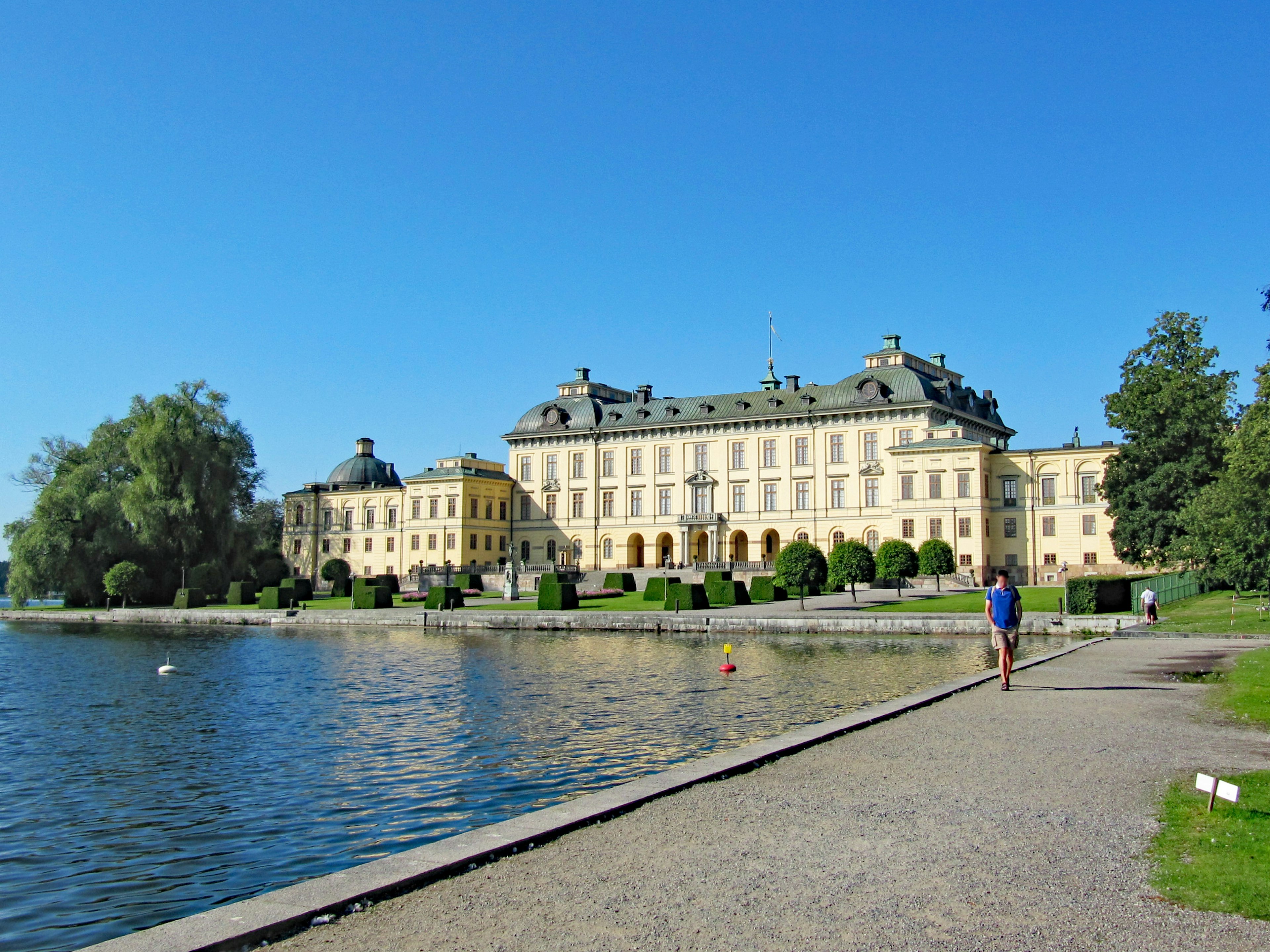 Impresionante palacio junto al lago bajo un cielo azul claro