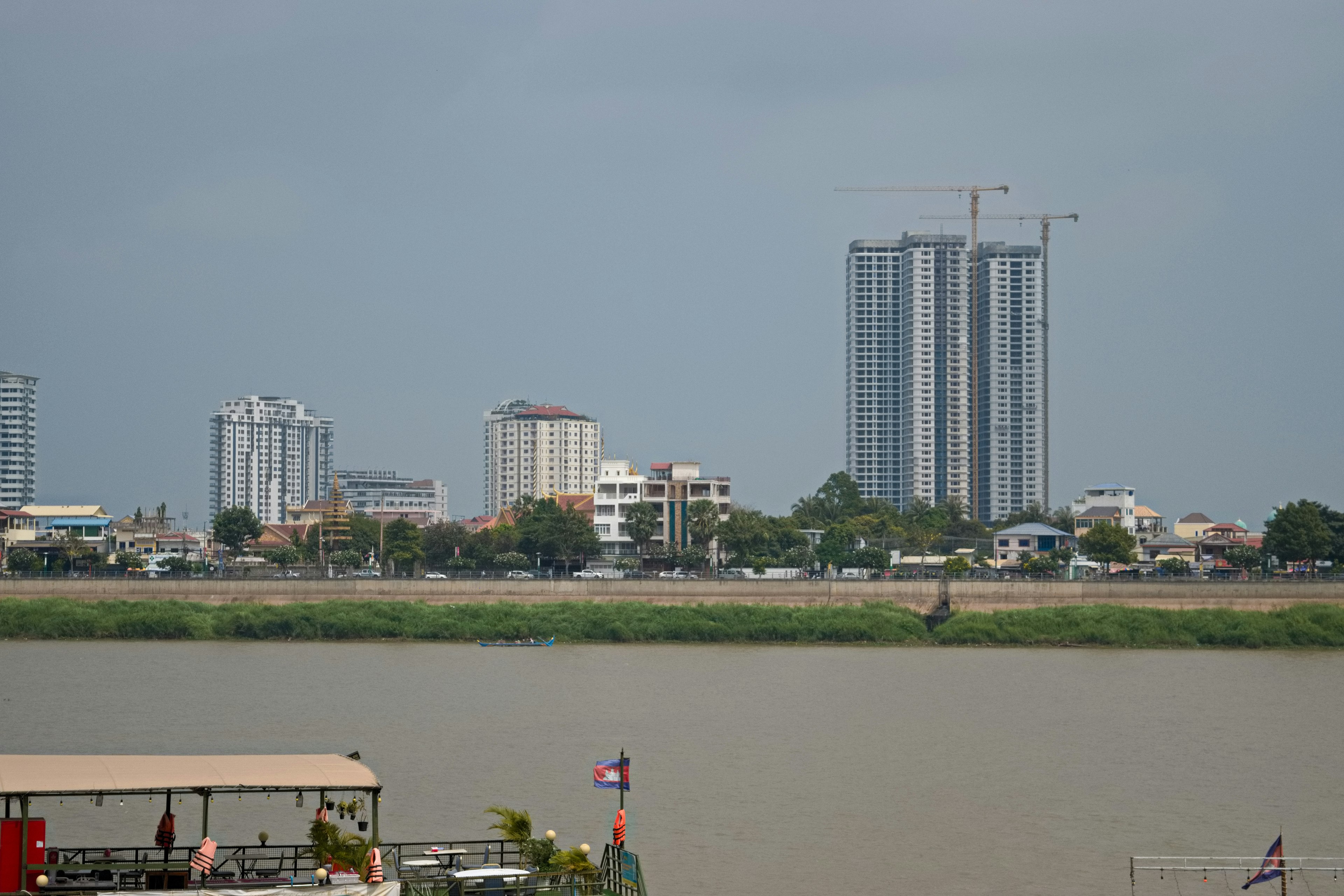 Cityscape featuring high-rise buildings and waterfront along a river