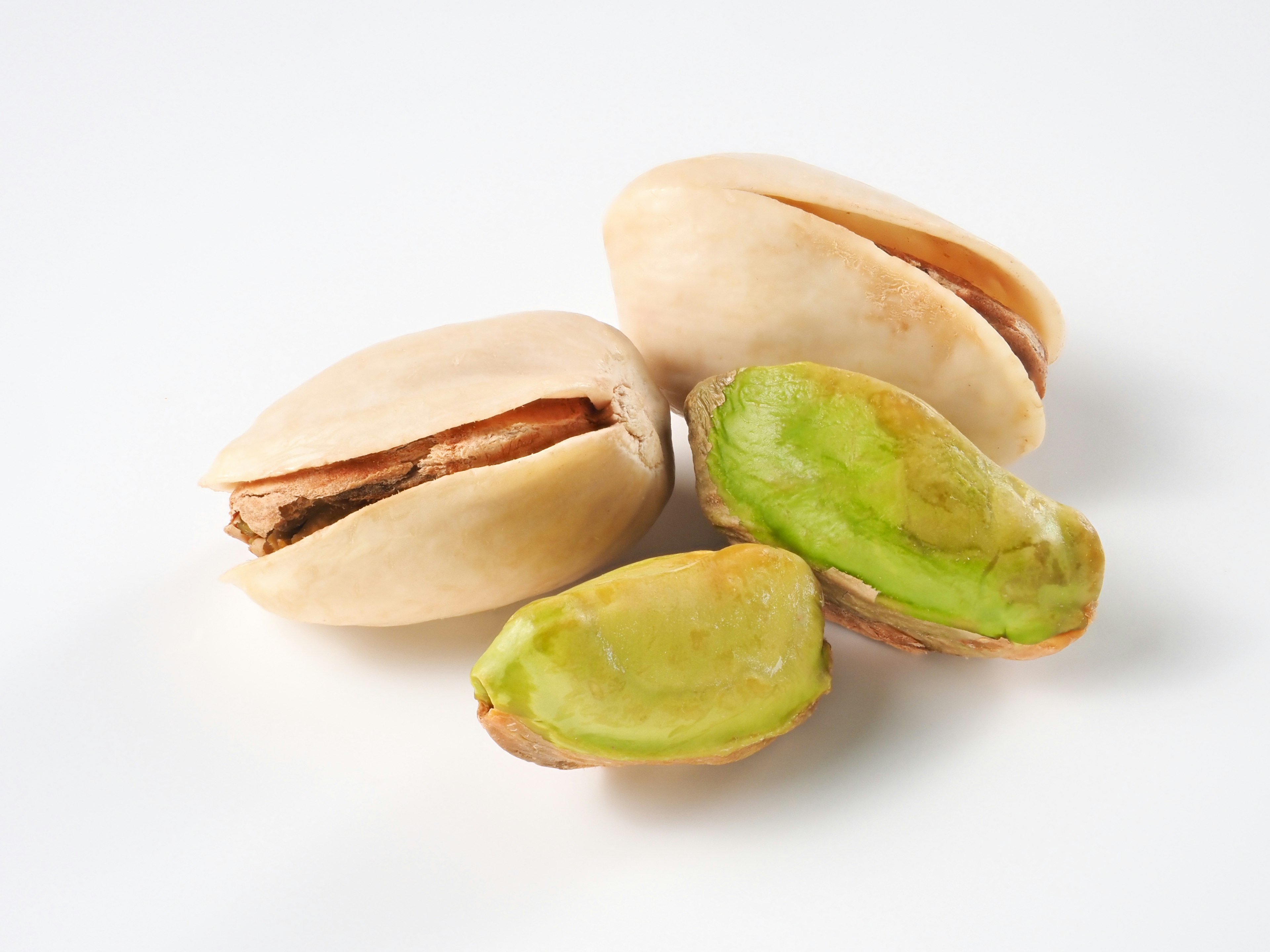 Pistachios in shell and shelled on a white background