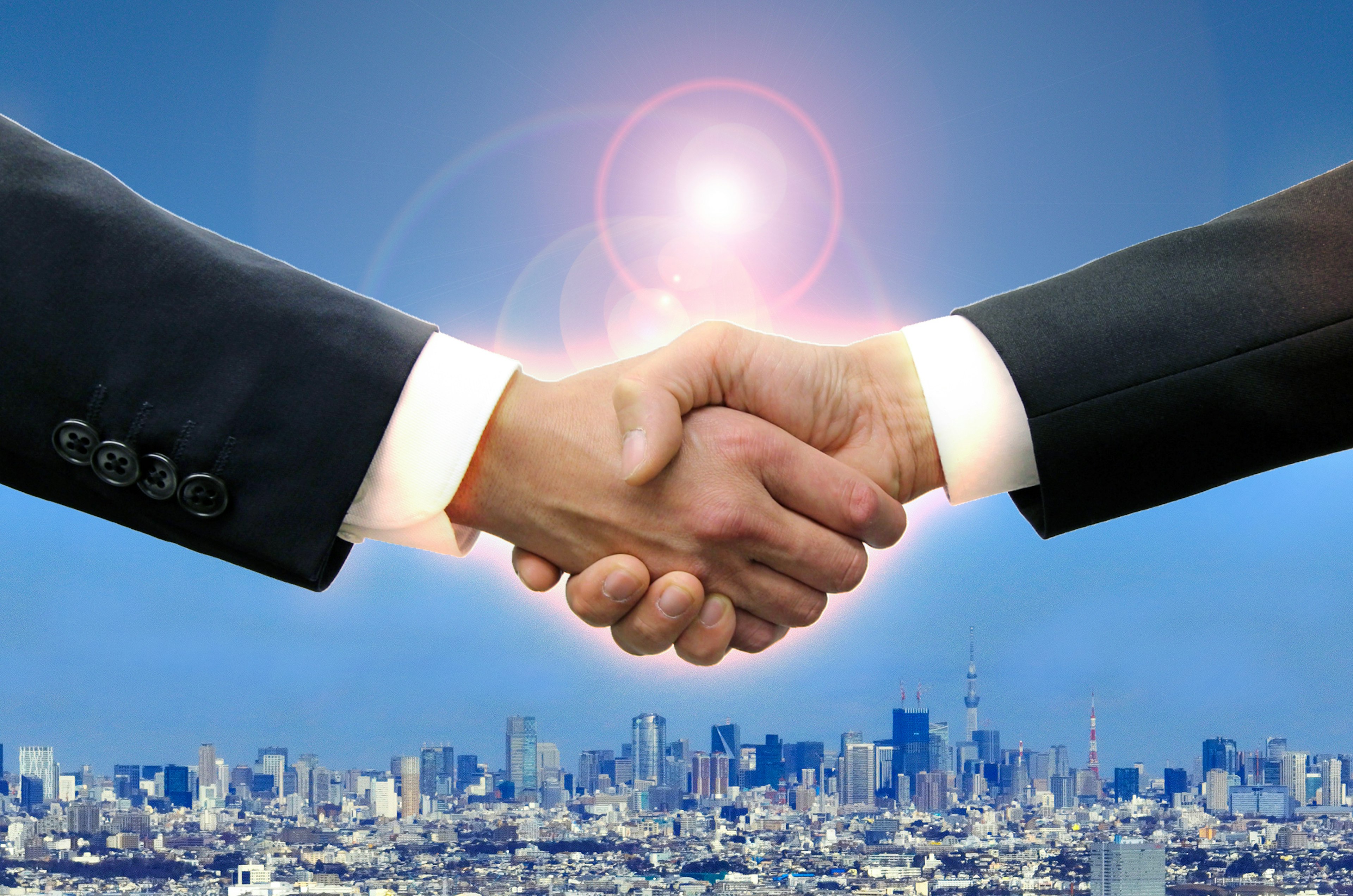 Two businessmen shaking hands against a city skyline