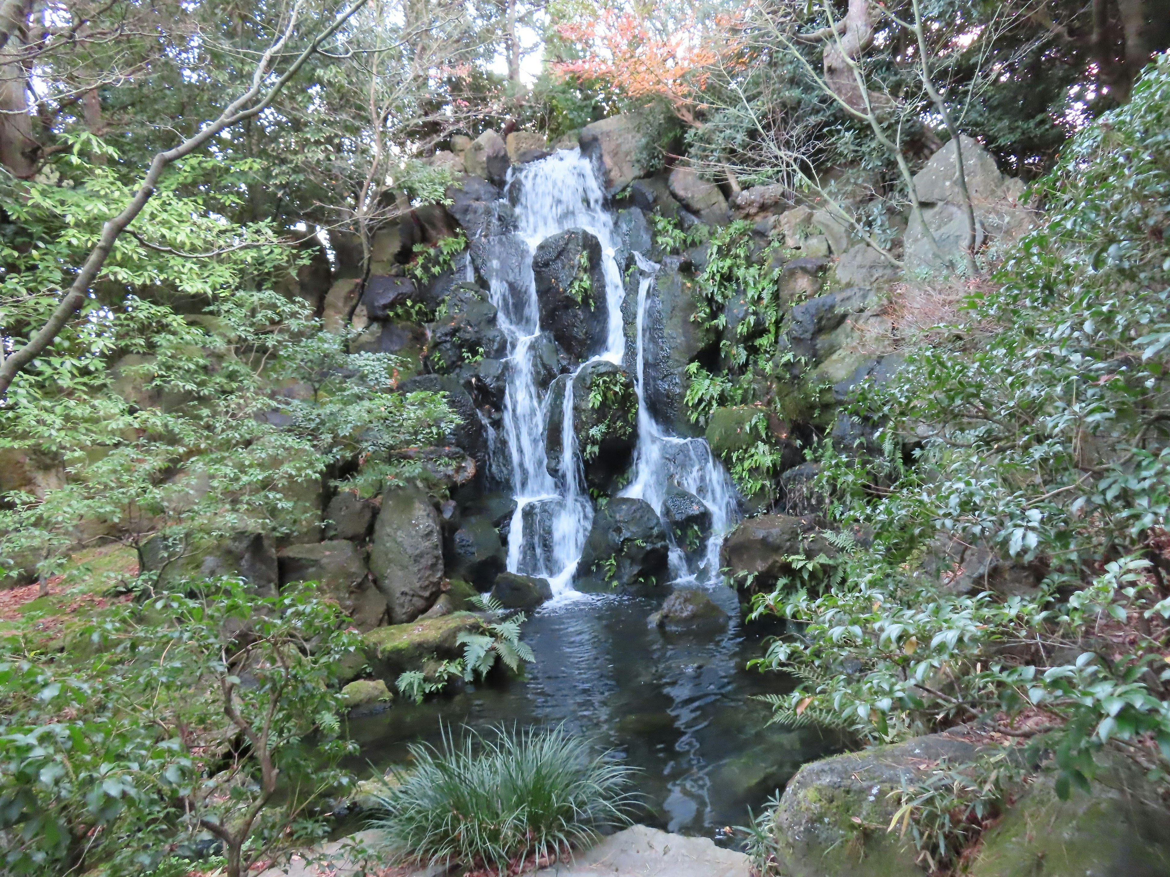 A beautiful waterfall surrounded by lush greenery and rocks