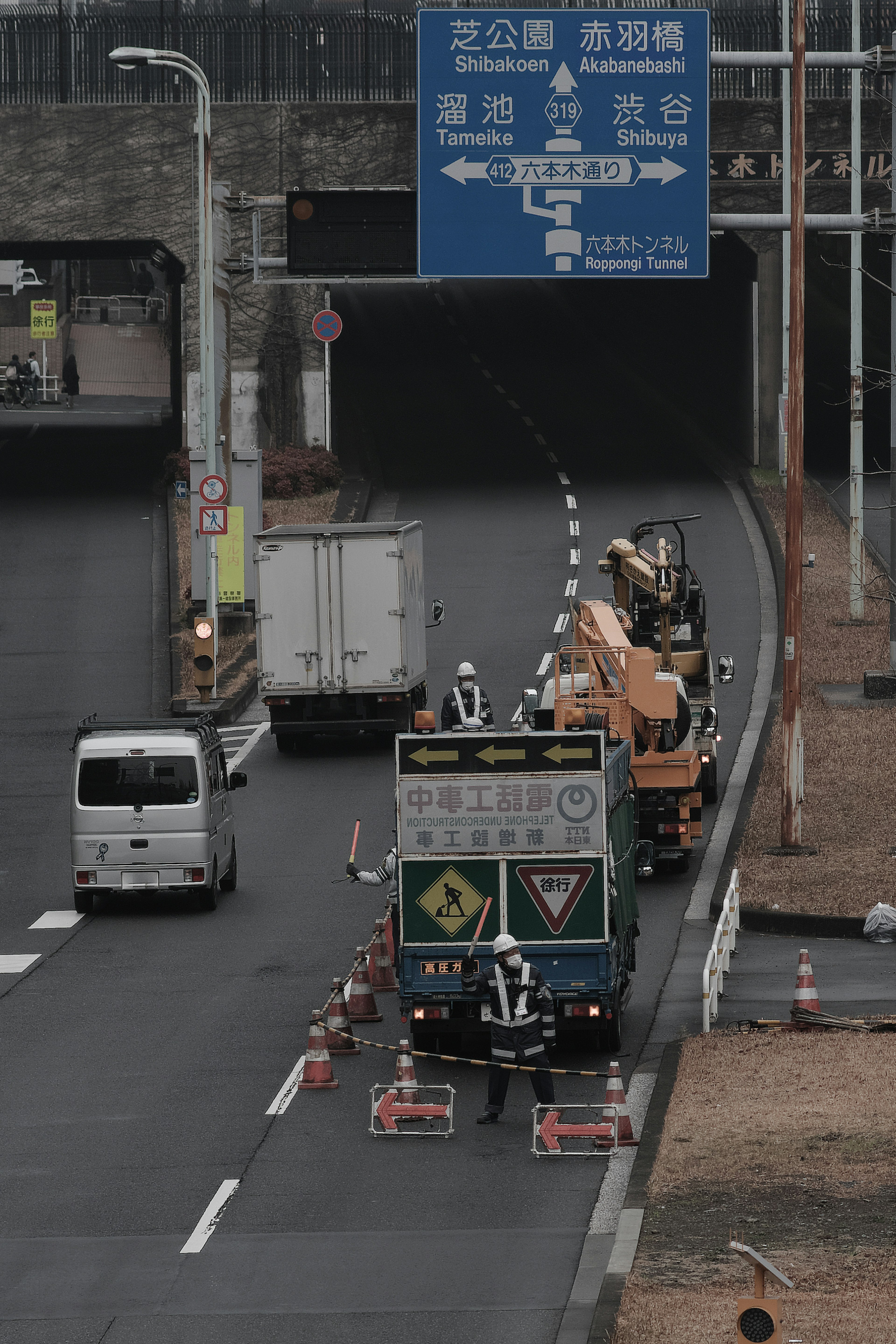 Construction trucks lined up on a highway