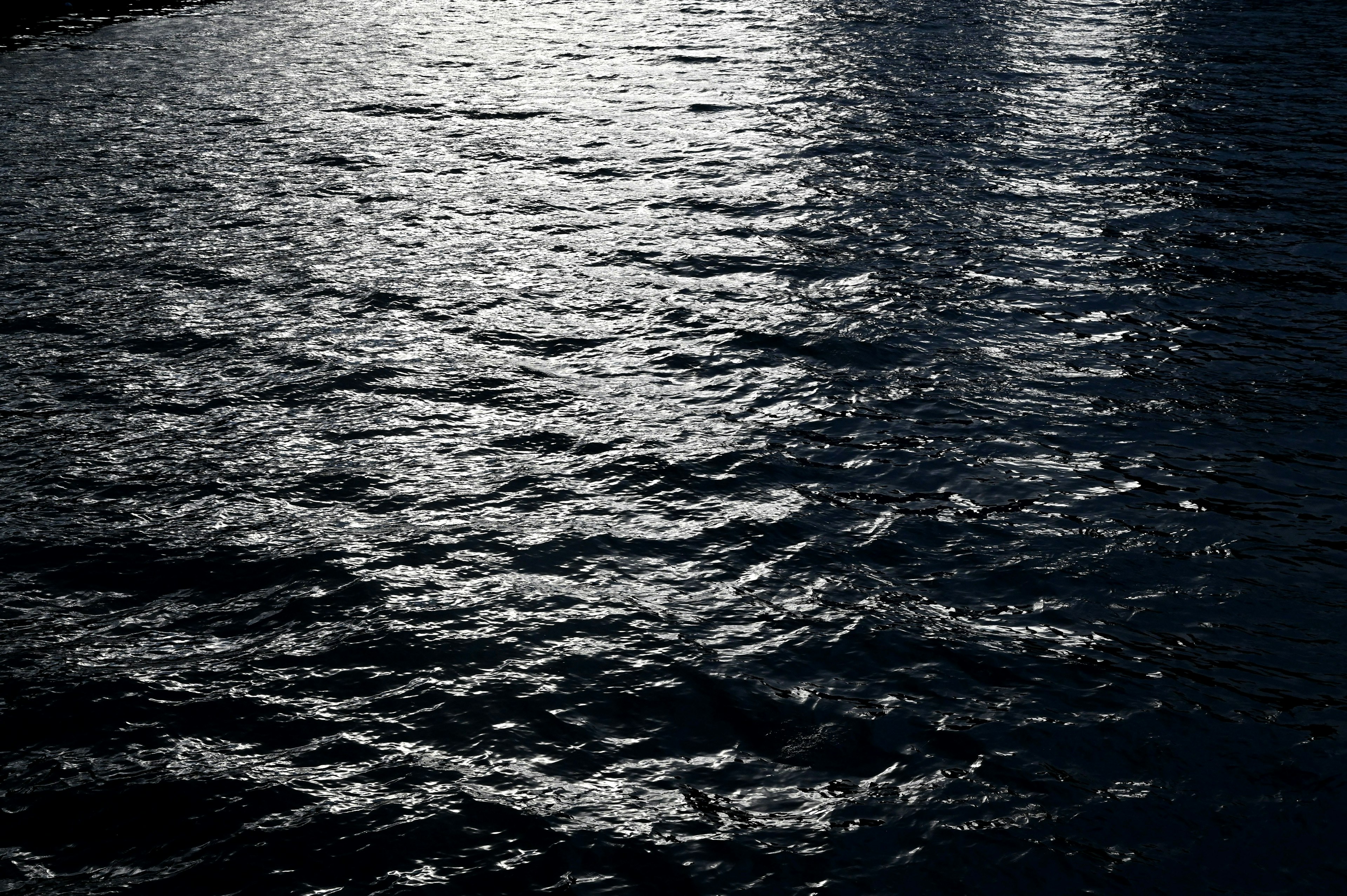 Image of dark water with beautiful reflections on the surface