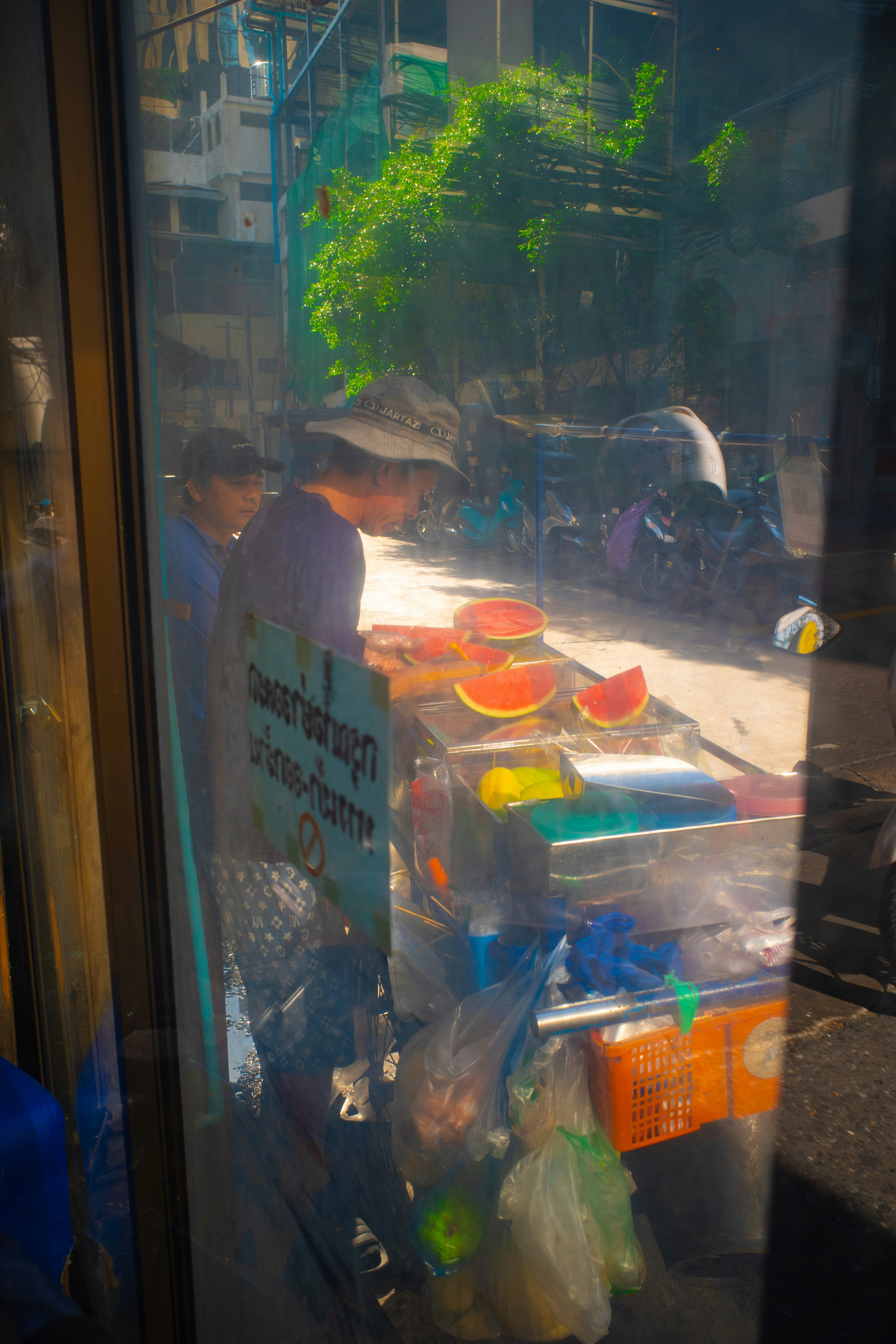 A vendor slicing fruit at a street cart