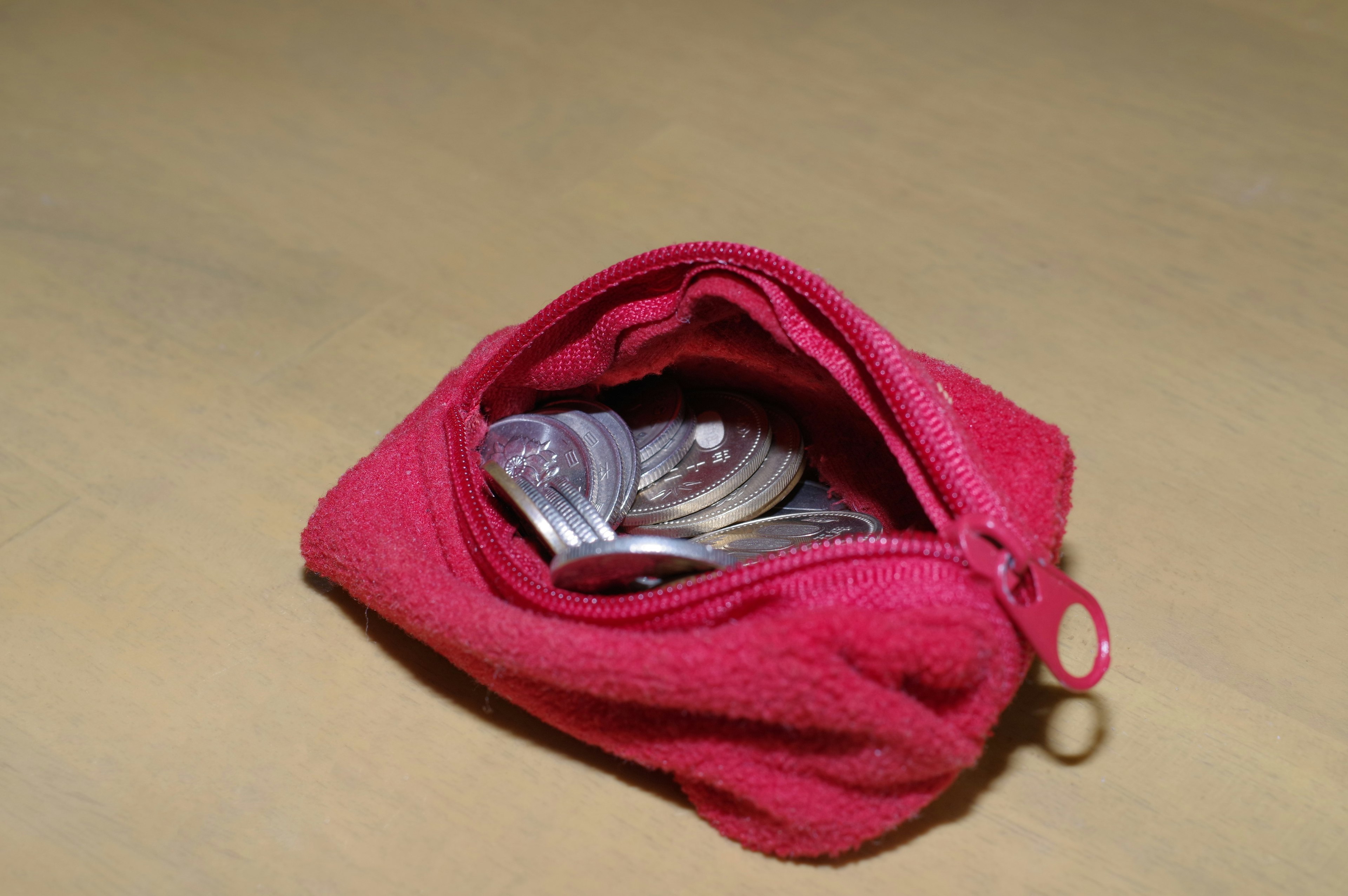 Red coin pouch filled with coins