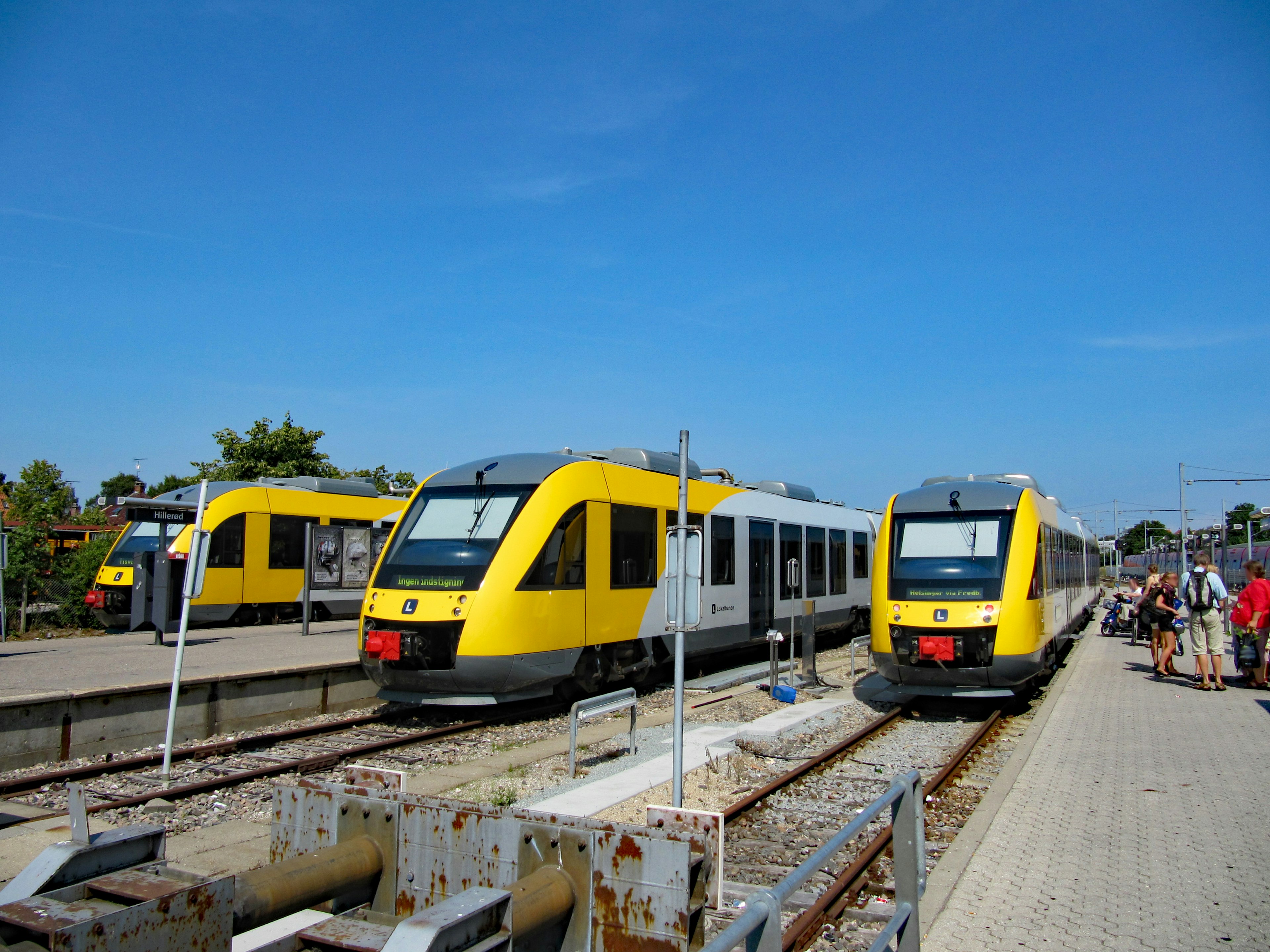 Yellow and white trains at a railway station