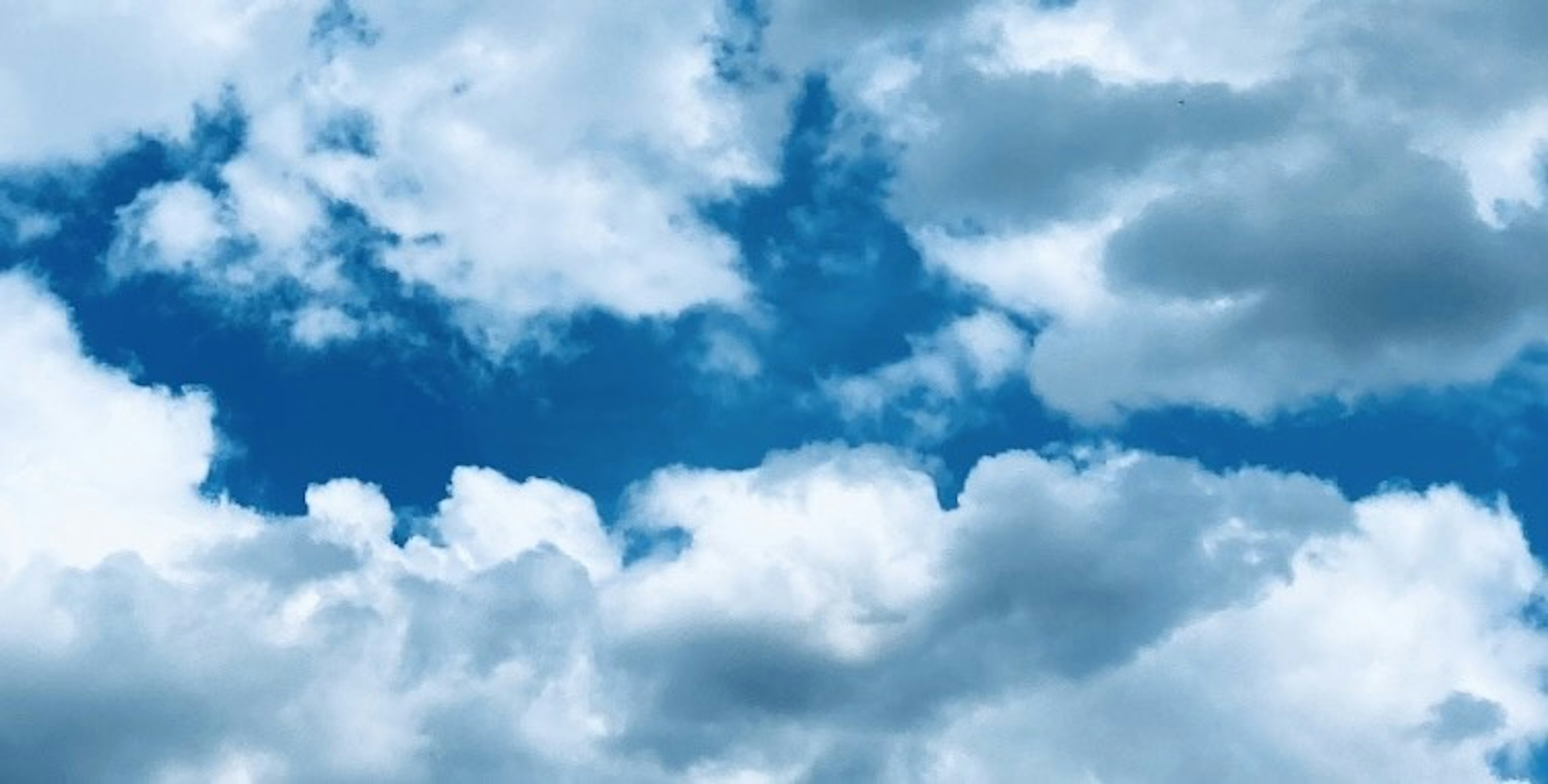 Blue sky with fluffy white clouds