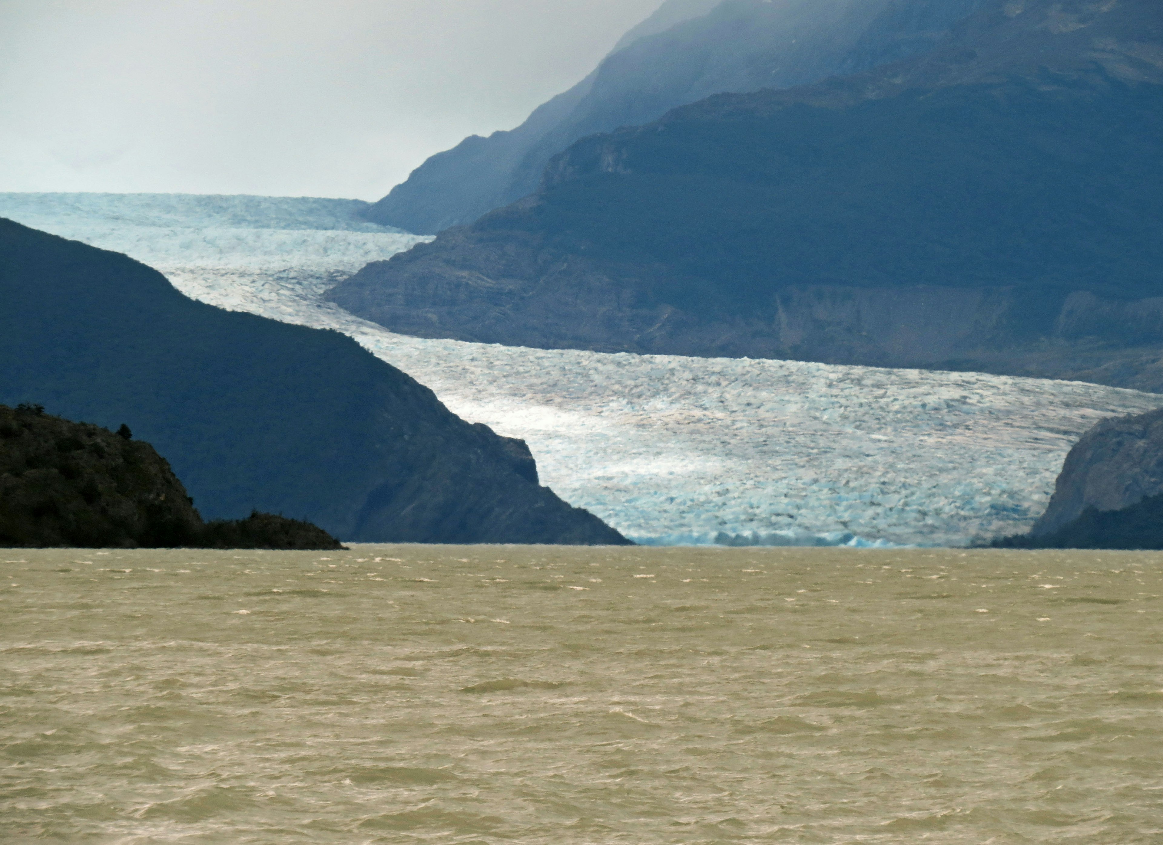 Lago de agua dulce con glaciar y montañas al fondo