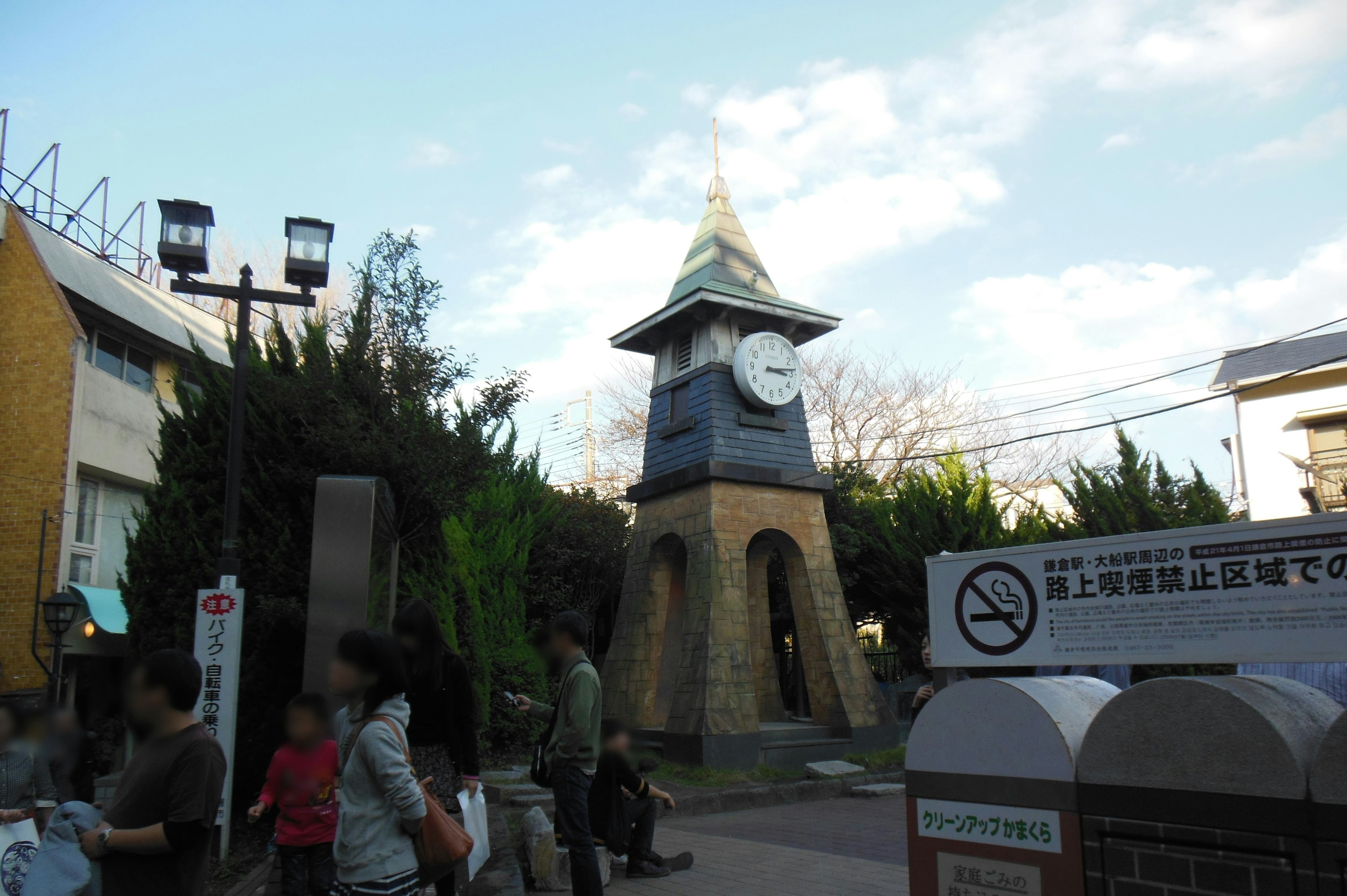 Park clock tower with visitors gathered around