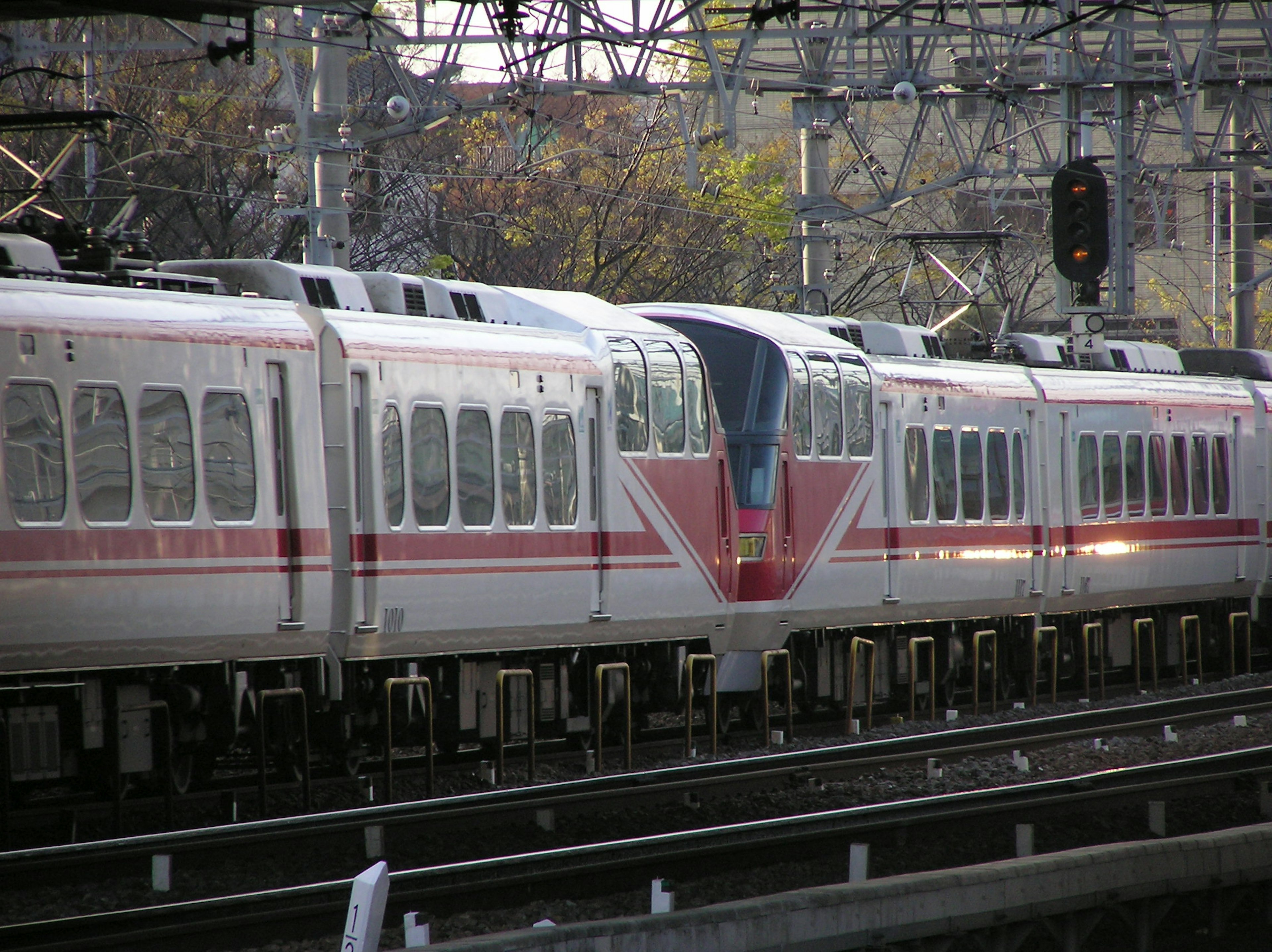 Train with distinctive red stripes running on tracks