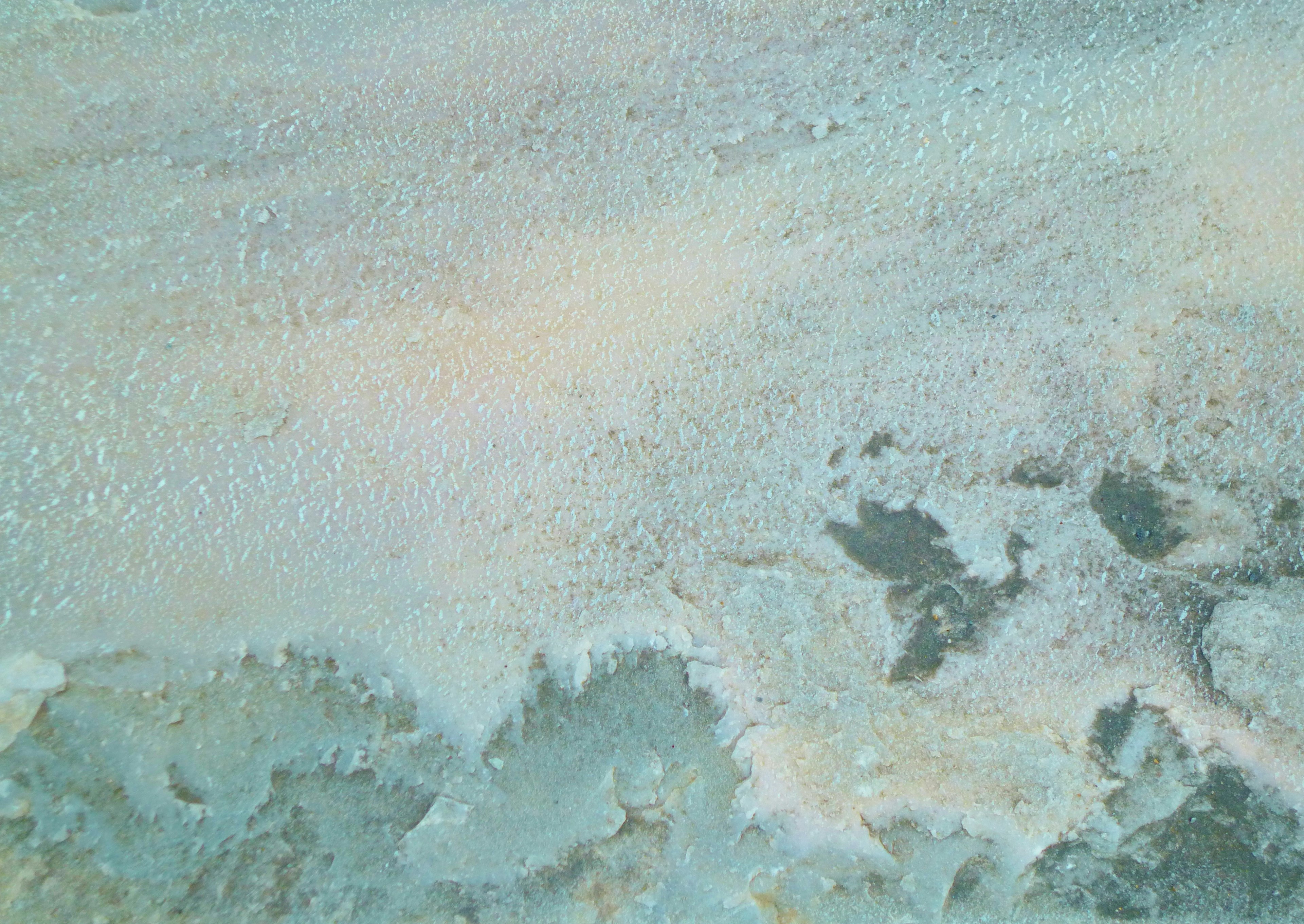 Textured surface of water with soft blue and green hues