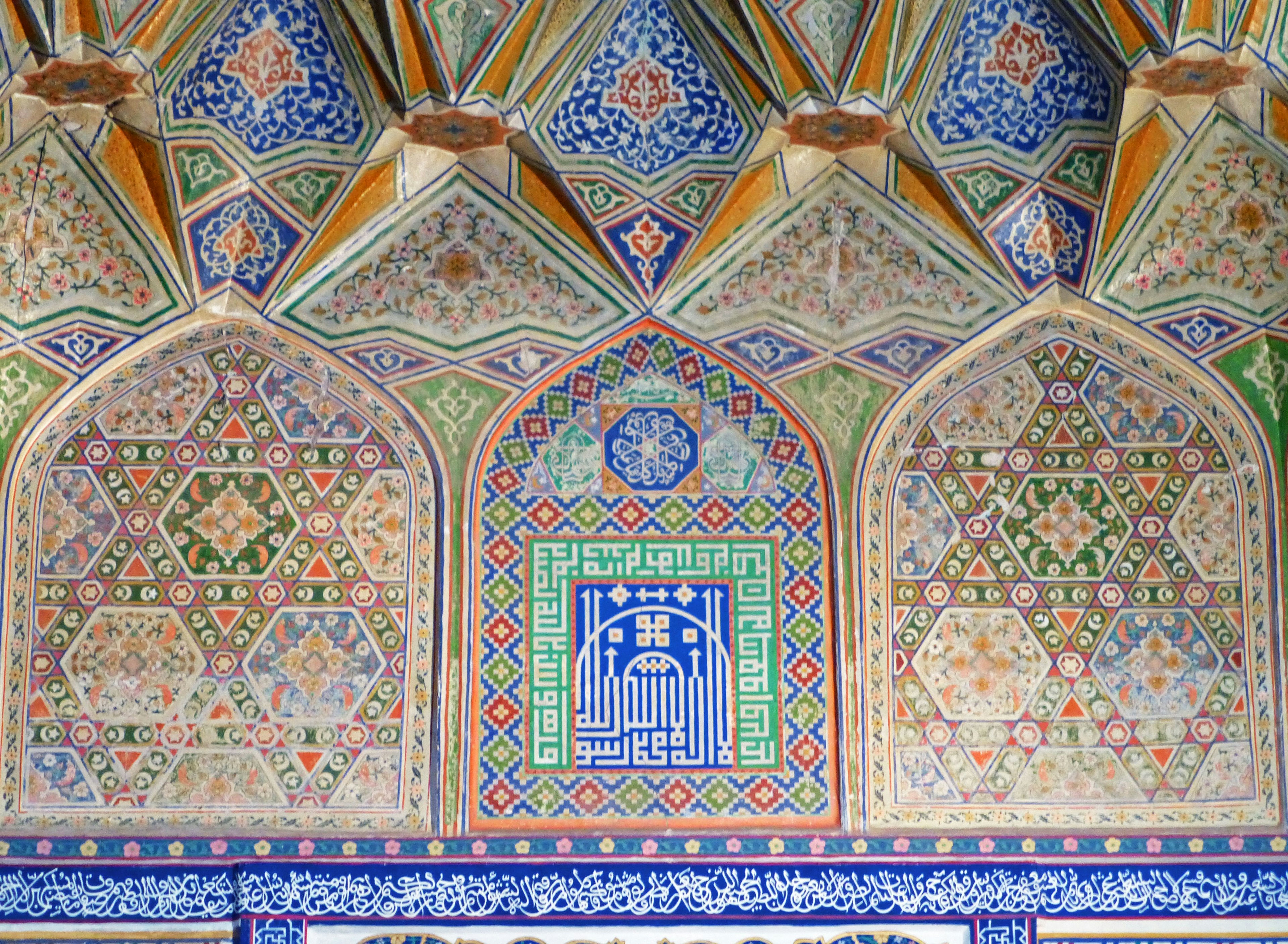 Wall of a Moroccan building featuring intricate tile work and geometric patterns