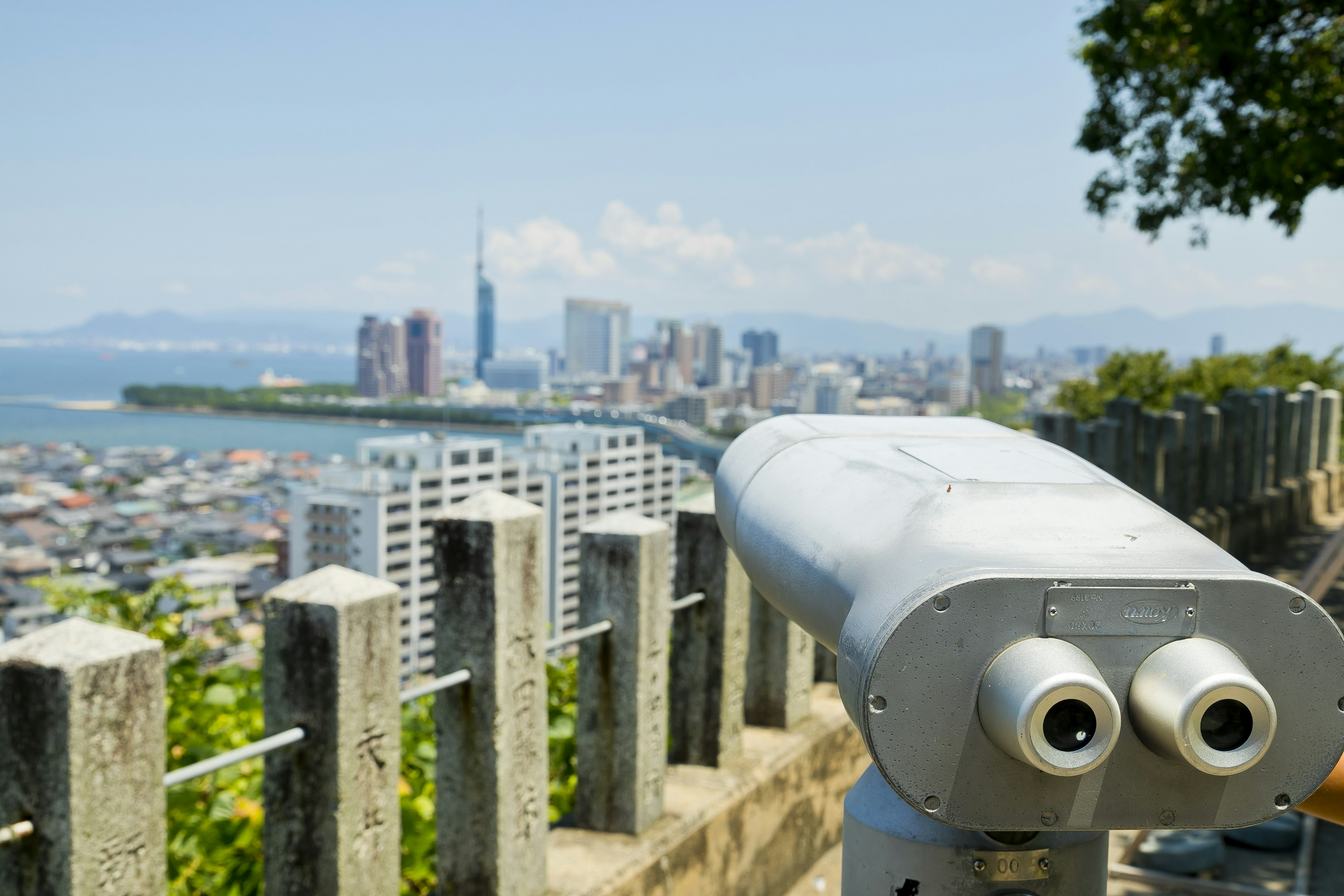 Viewpoint binoculars overlooking a city skyline