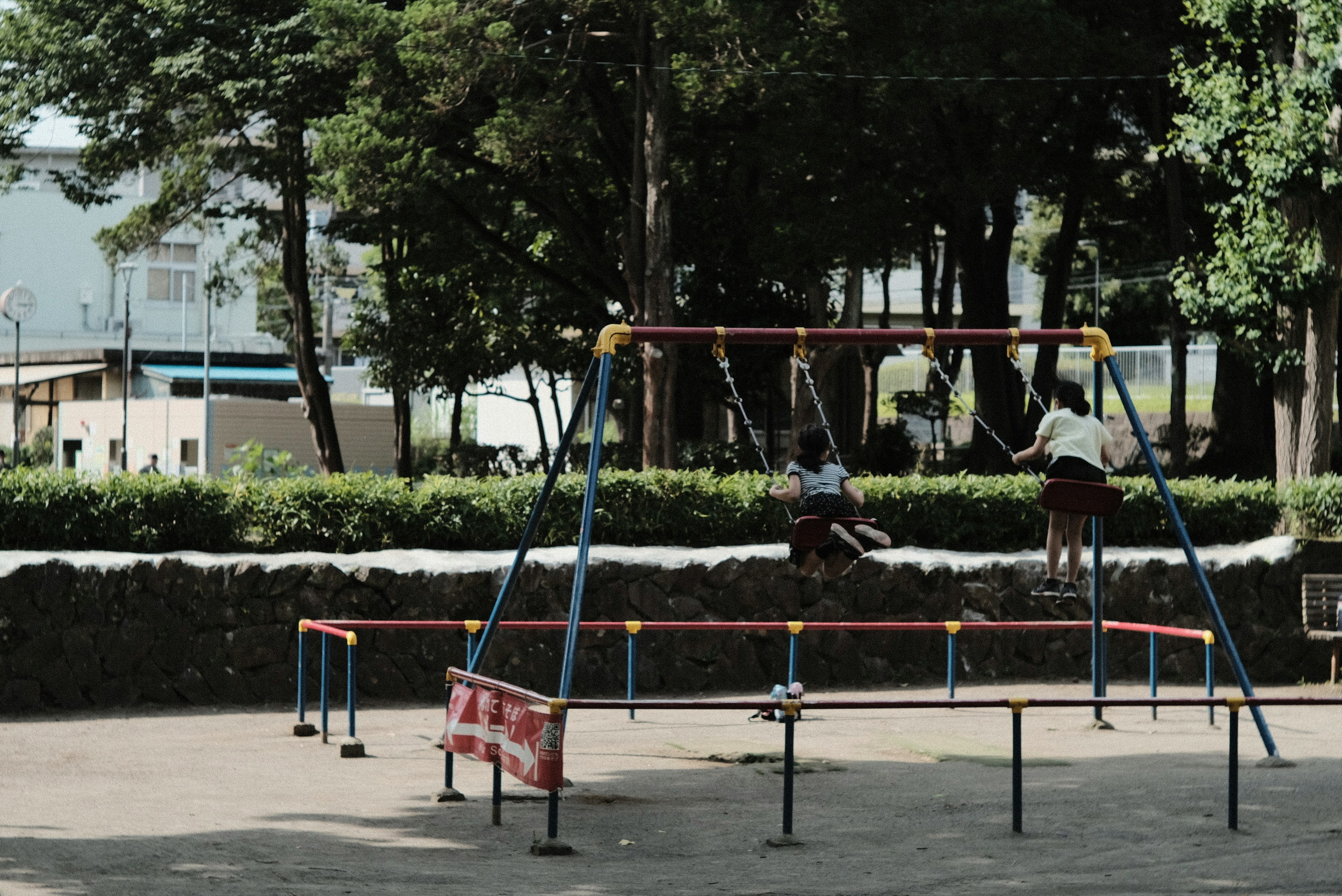 Children playing on swings in a park