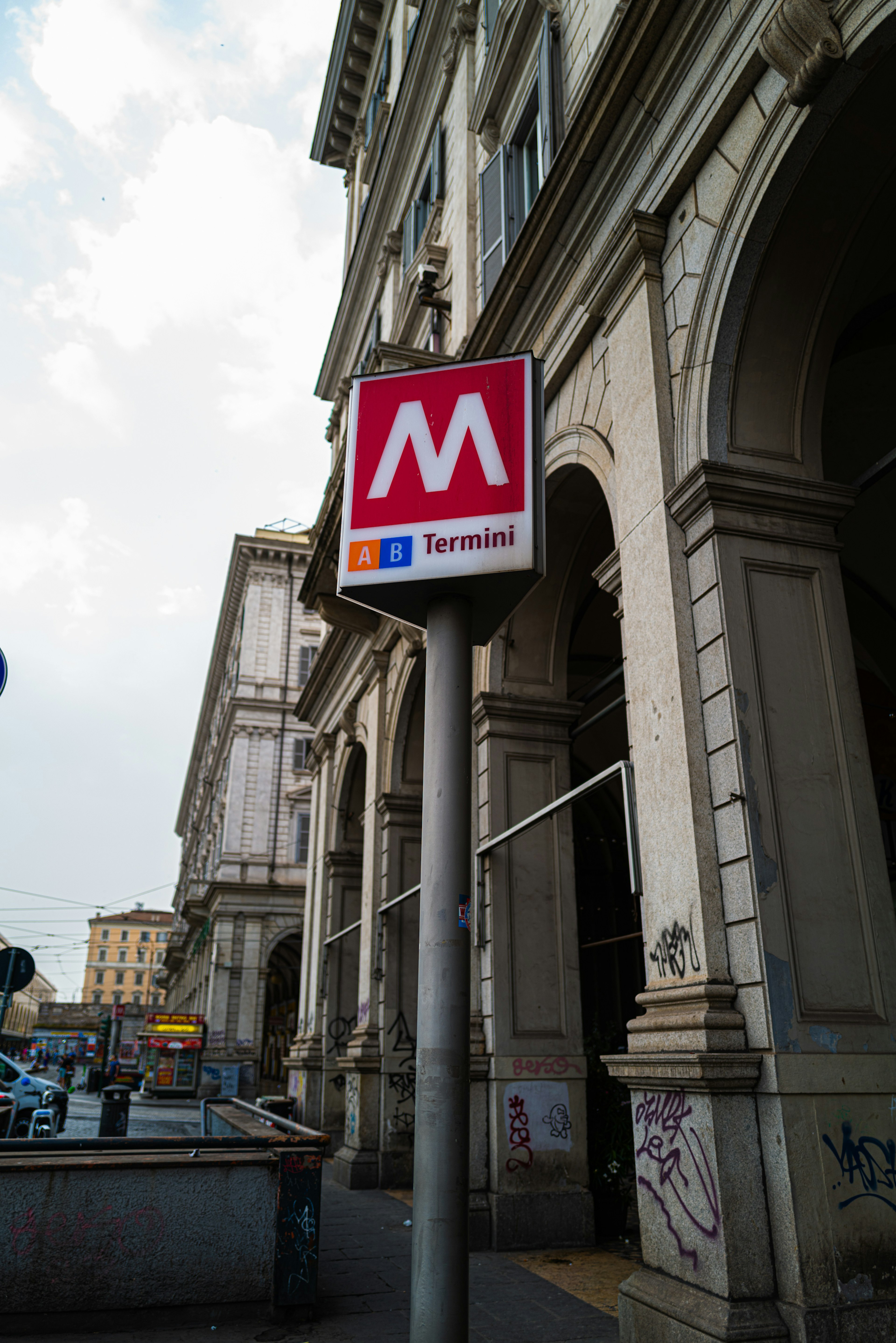 Metro sign in front of a classic building