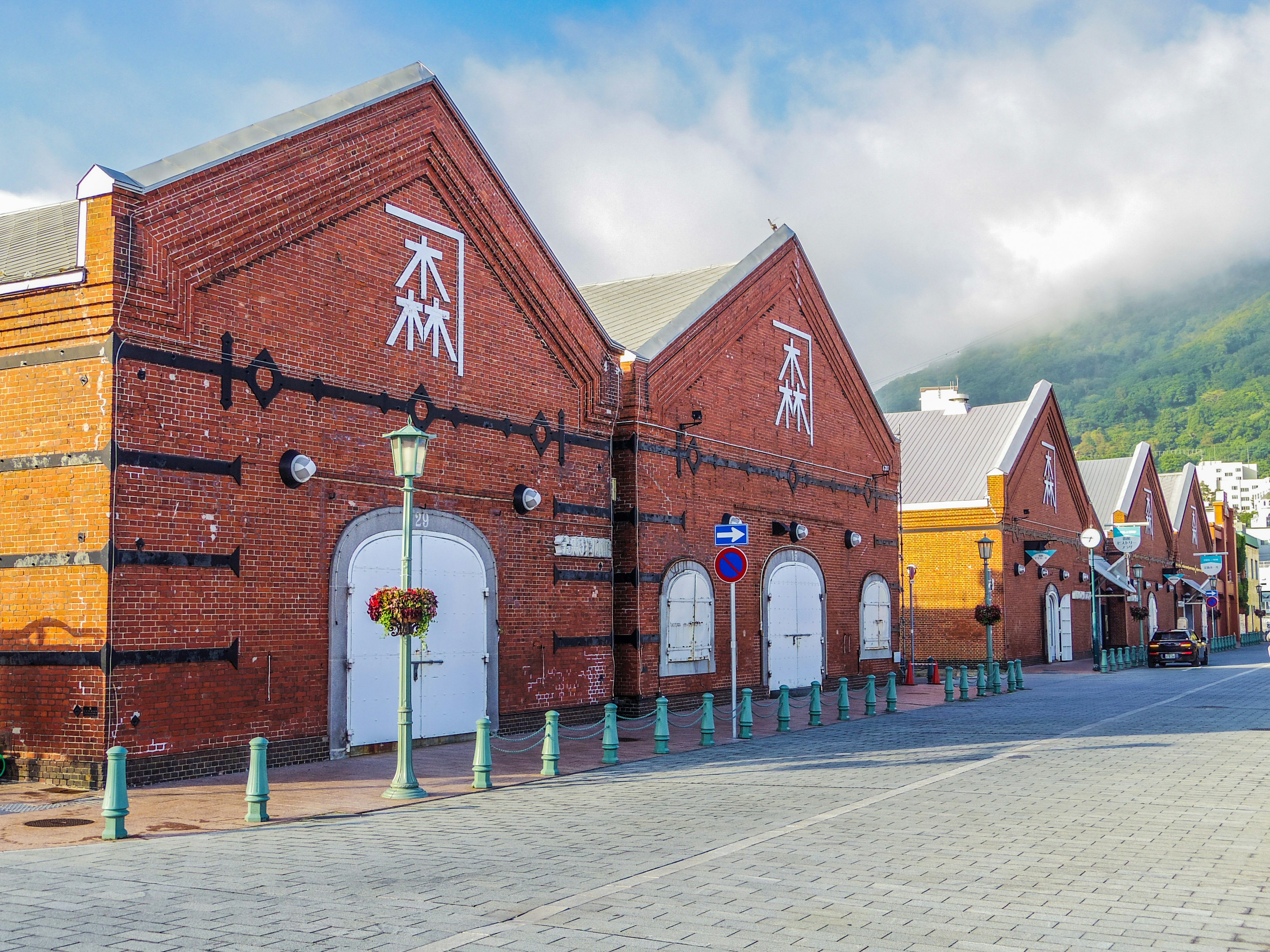 Street view of red brick buildings with white doors