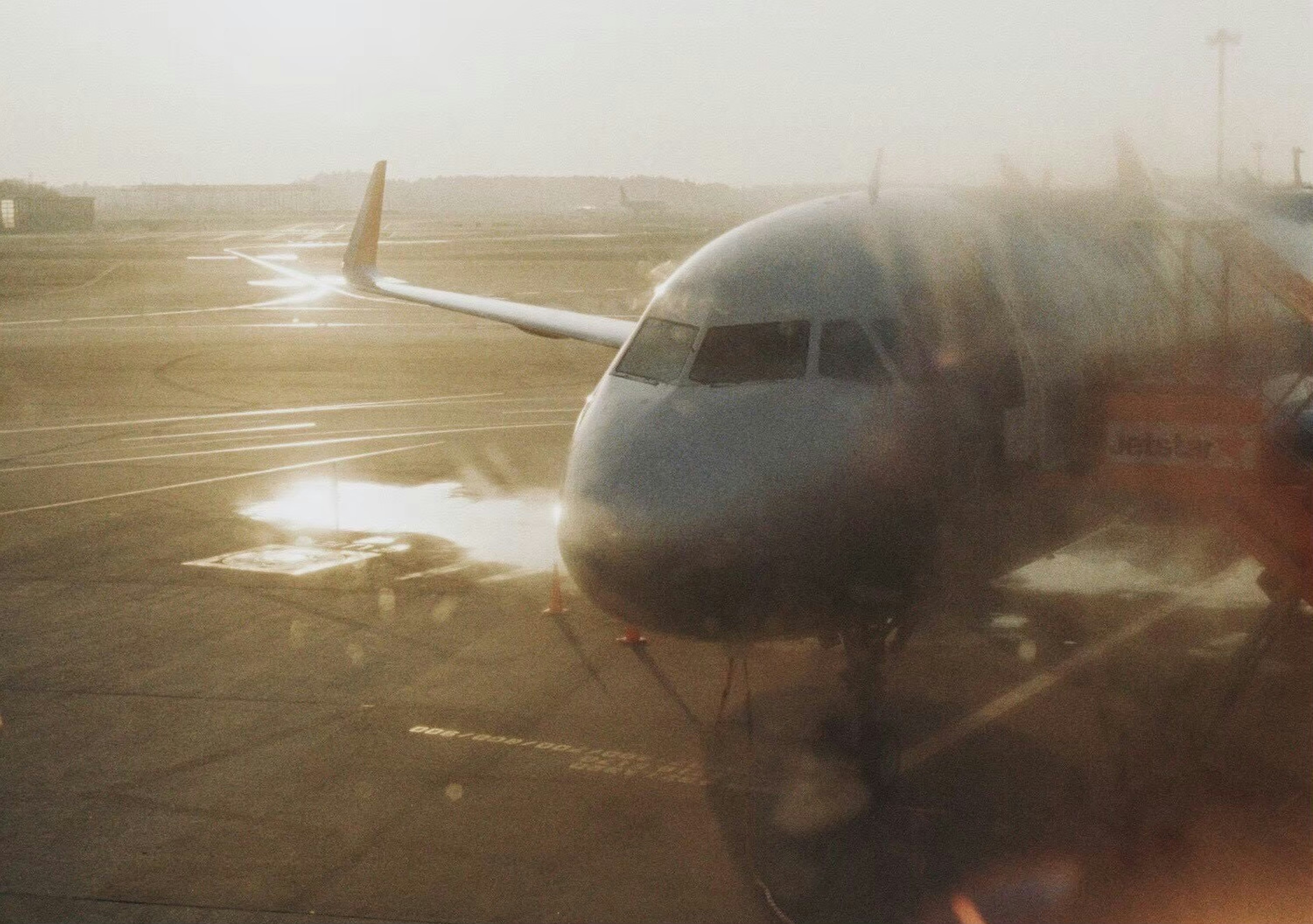 Blurry image of an aircraft parked on the airport runway