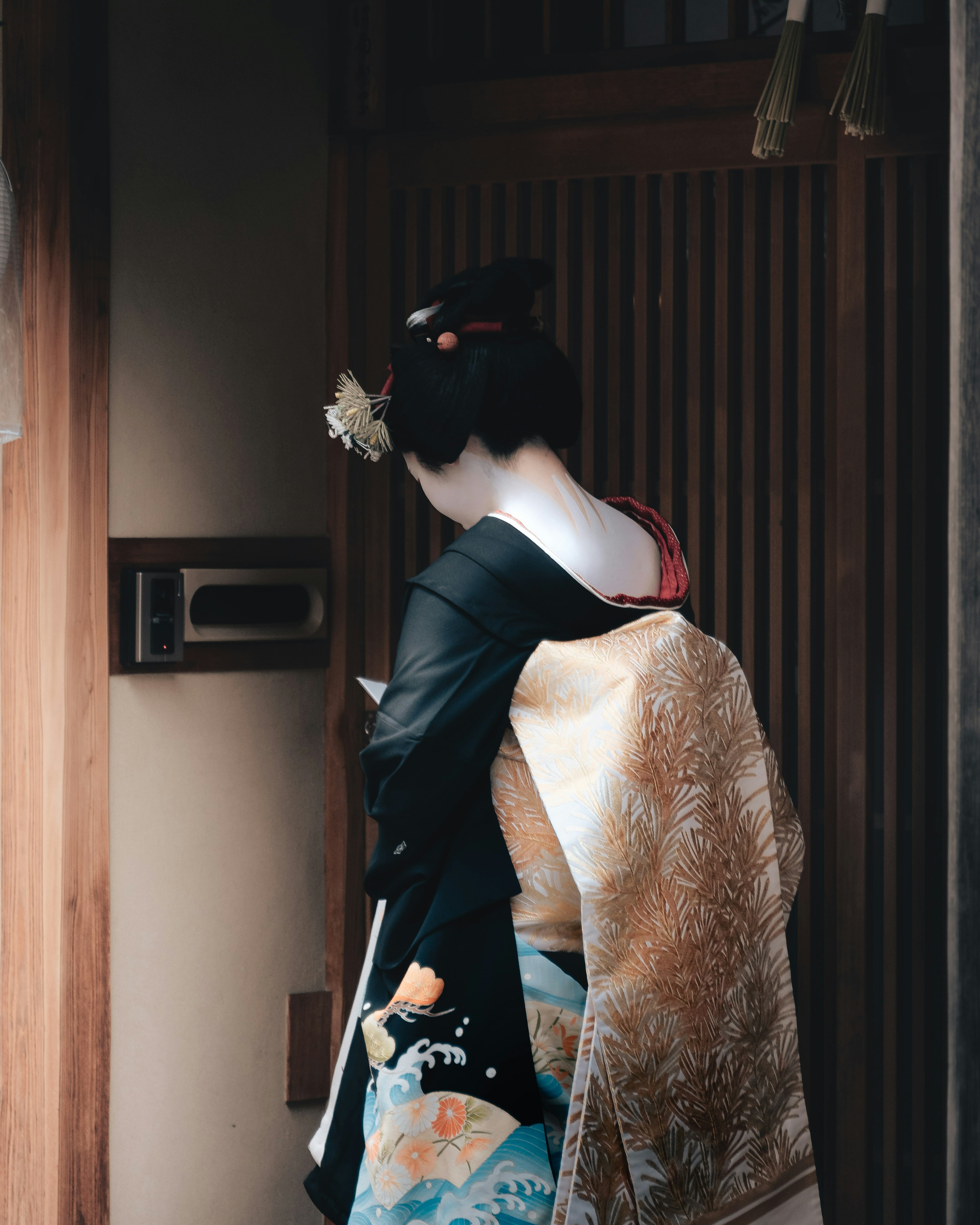 A woman in kimono standing with her back turned