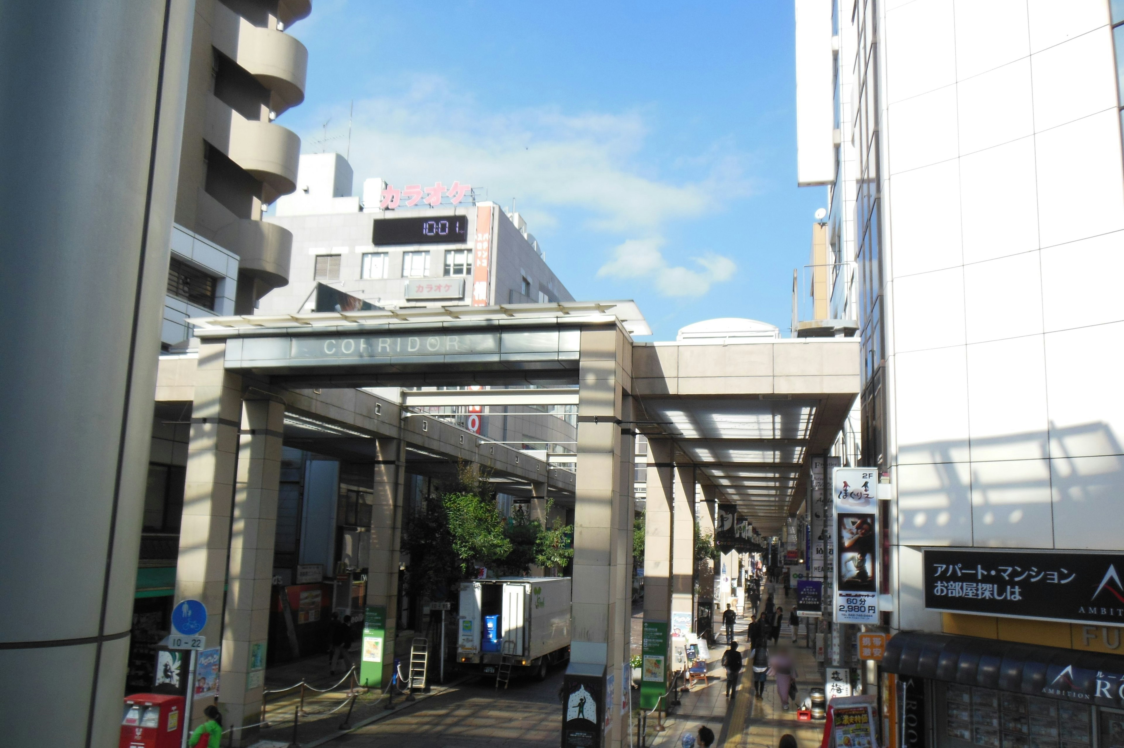 Urban street view with commercial buildings and a clear blue sky