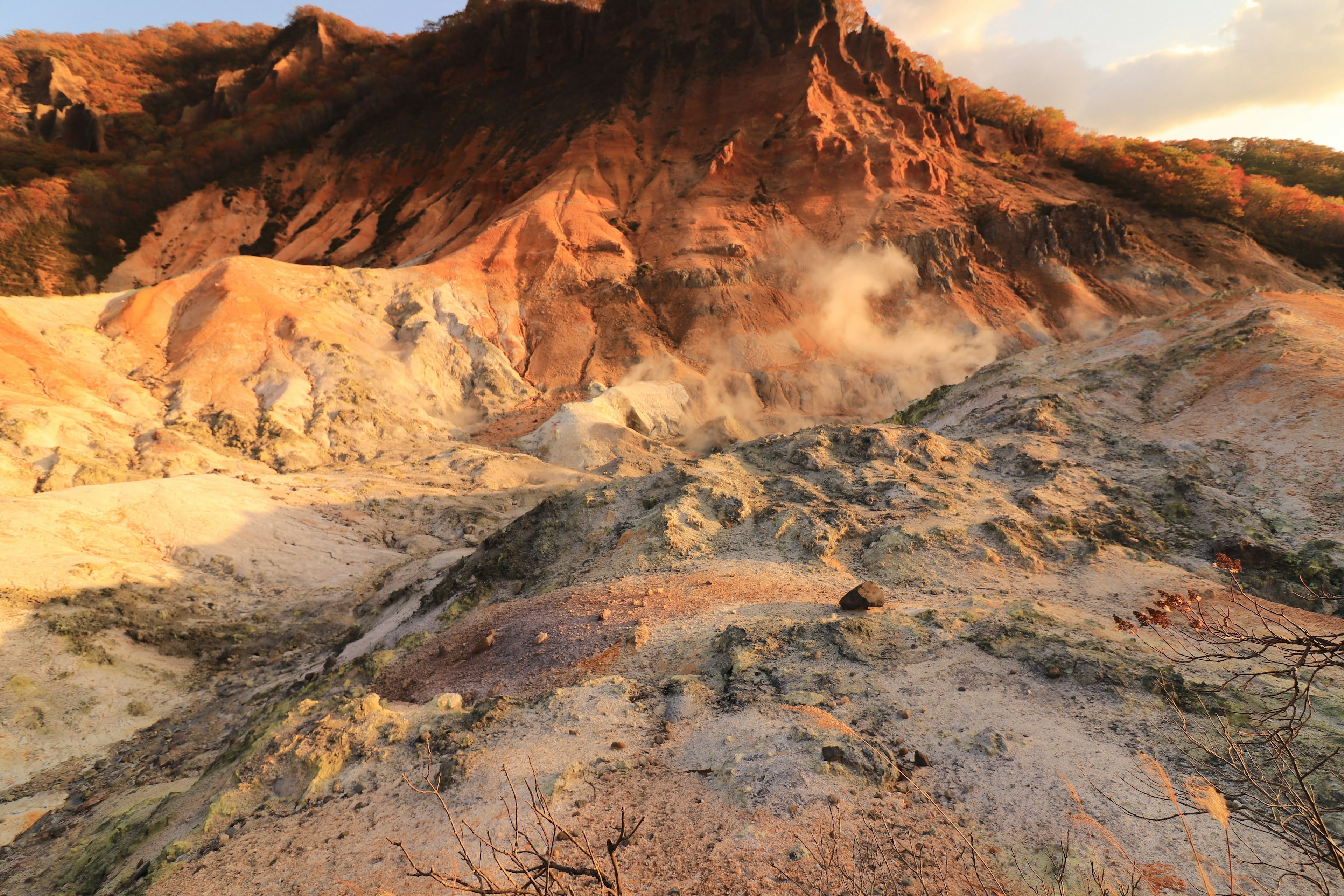 Pemandangan vulkanik yang menunjukkan fitur geologis aktif dengan medan dan warna yang bervariasi