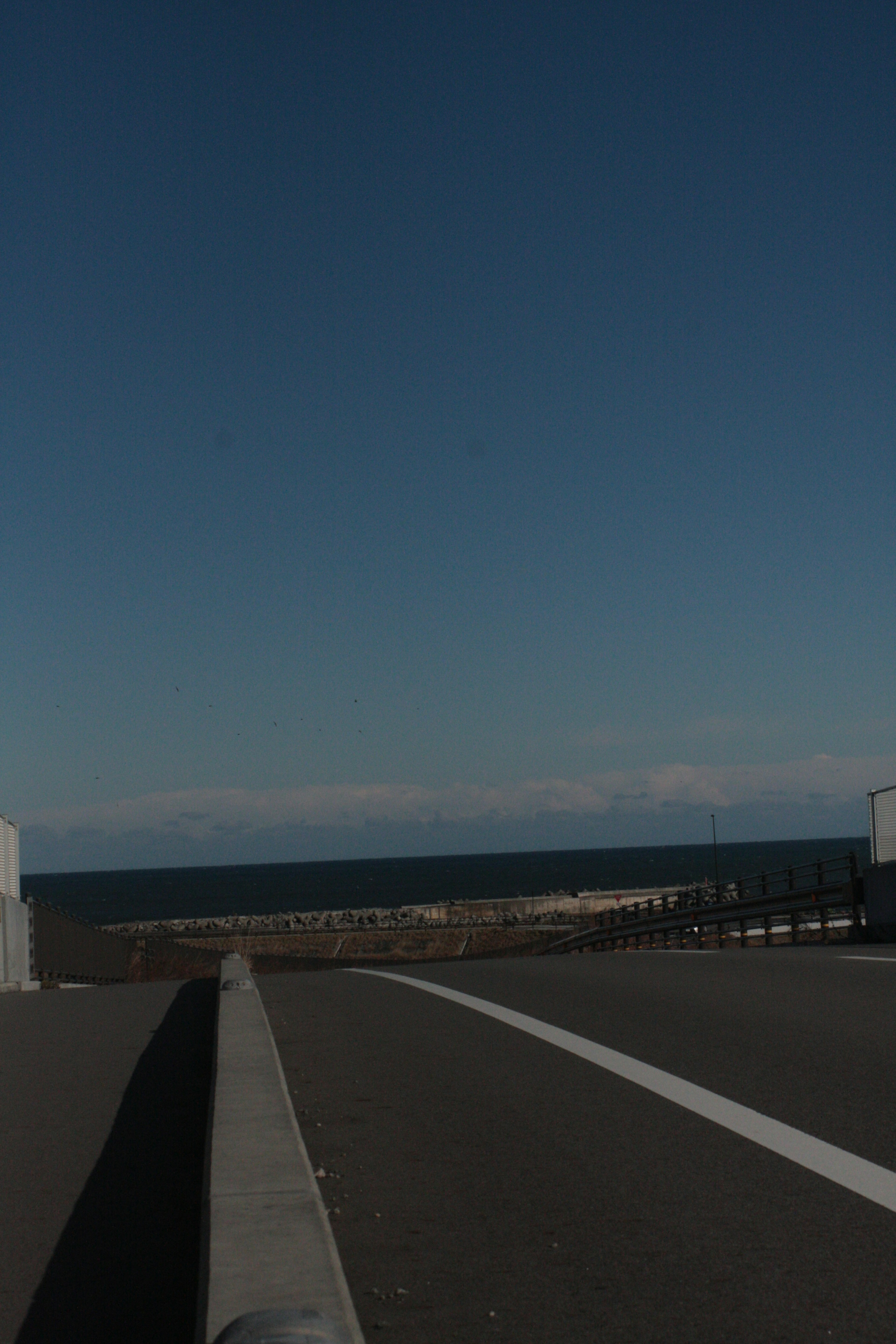 Road view with blue sky and ocean landscape