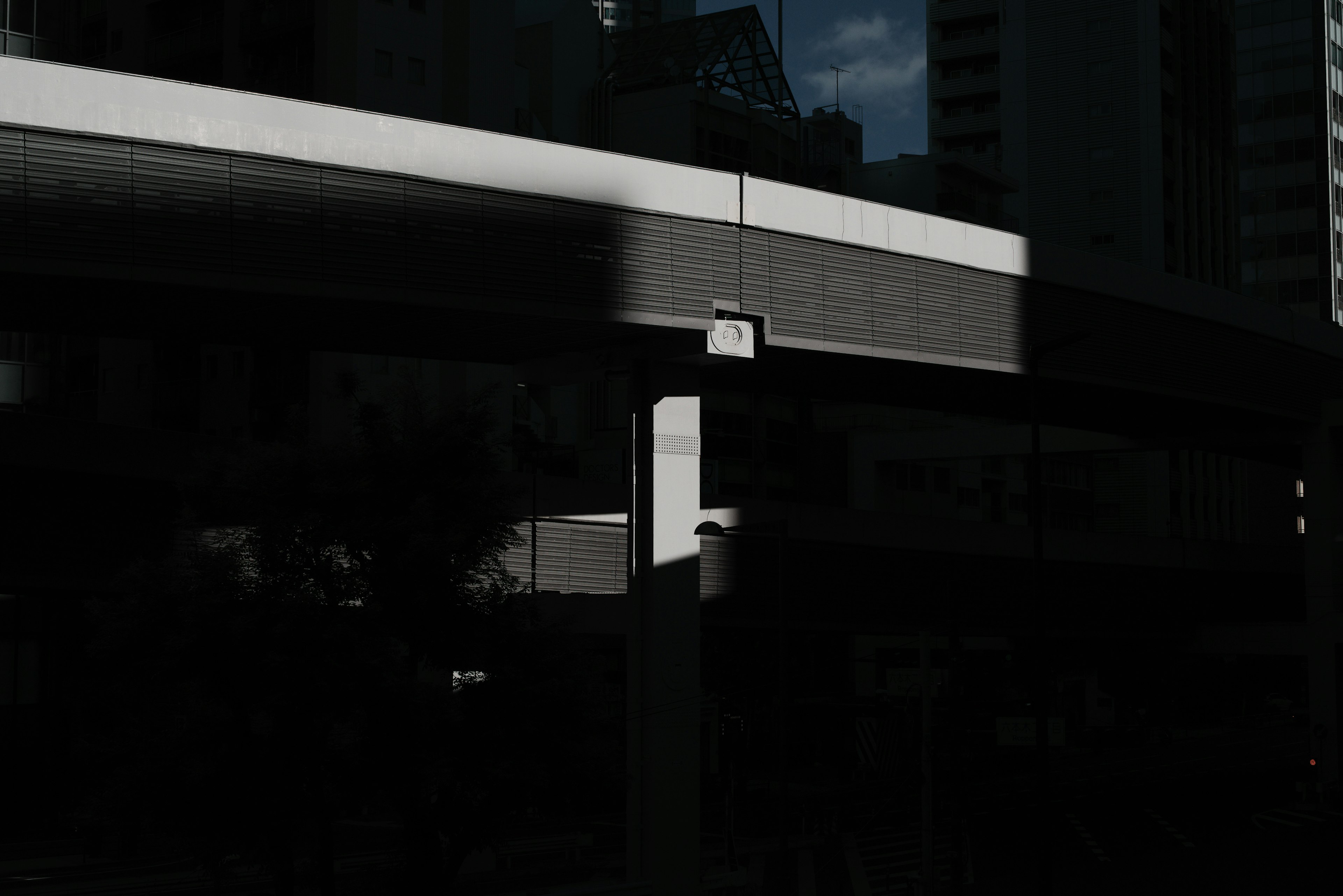 Urban landscape with shadows of buildings and a structure