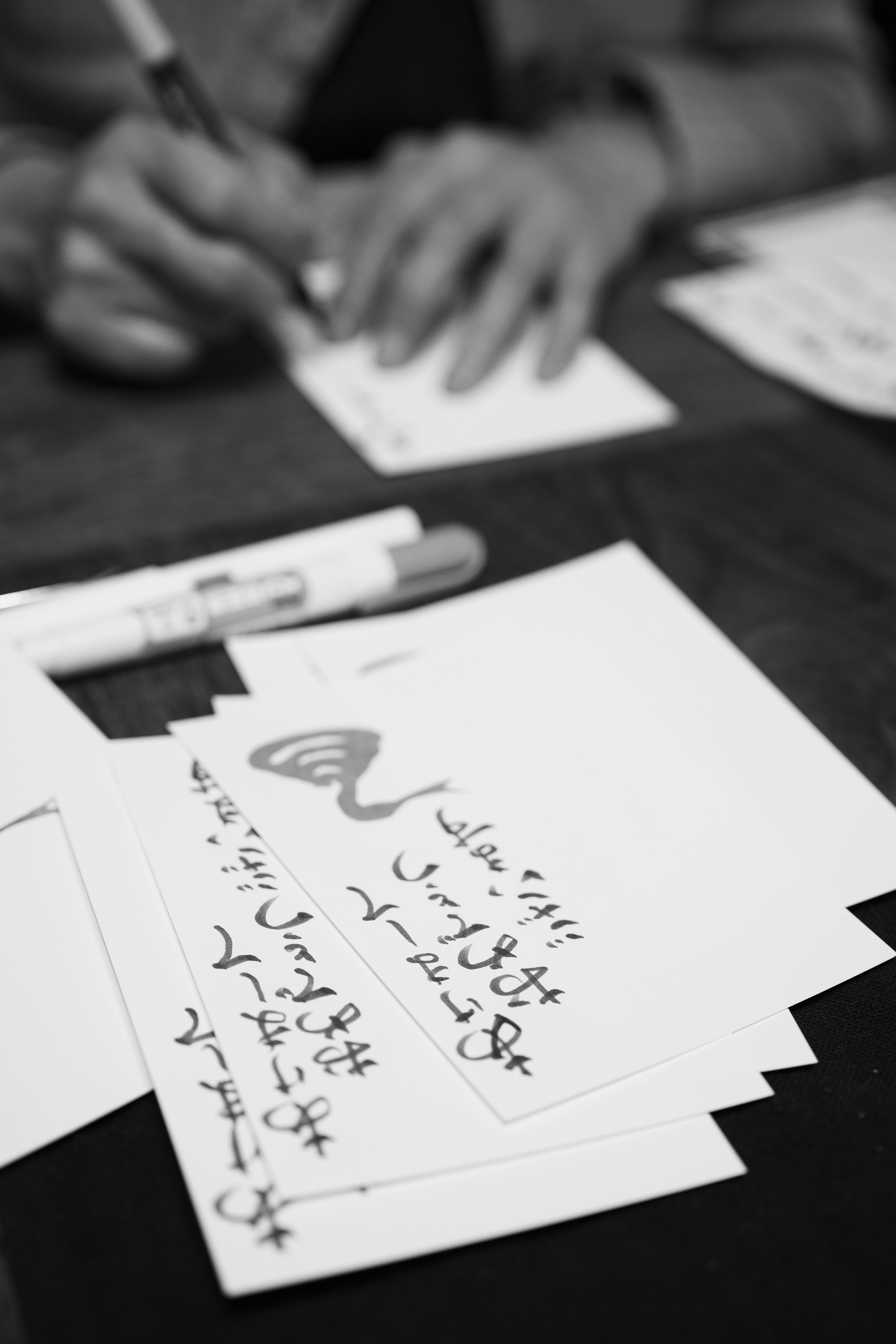 Handwriting on blank postcards with a pen in use