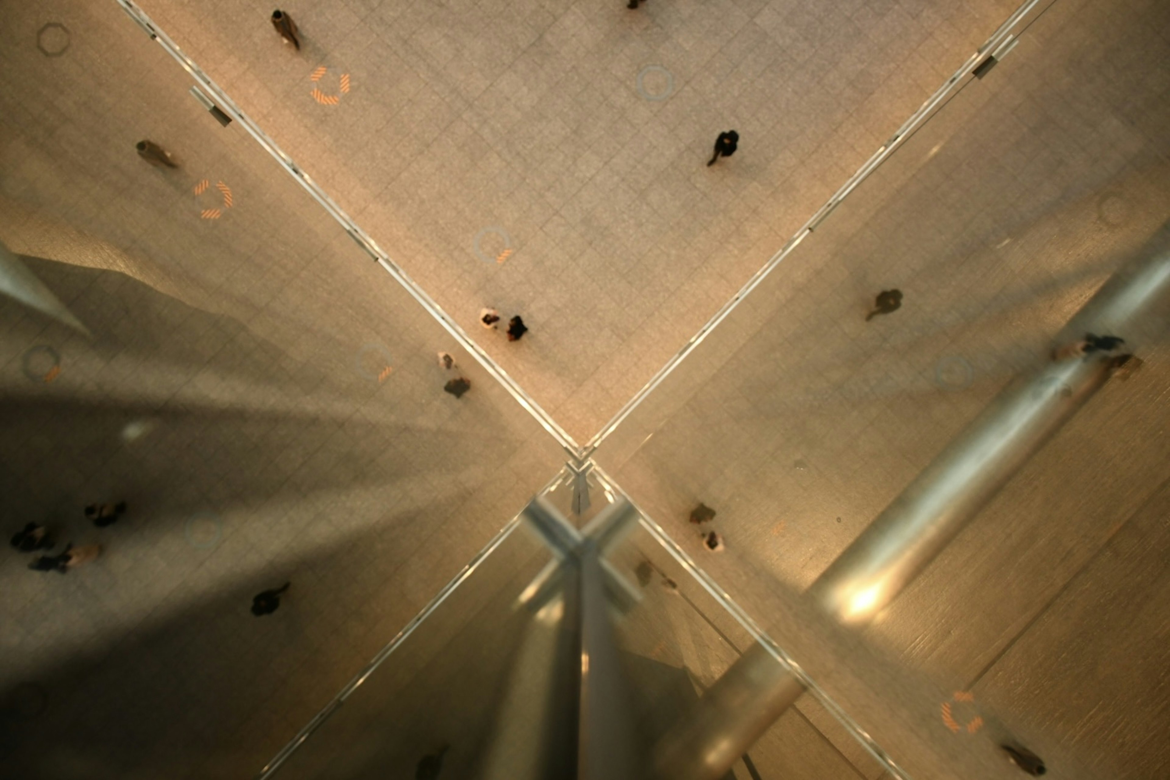 Image from below a ceiling showing people walking