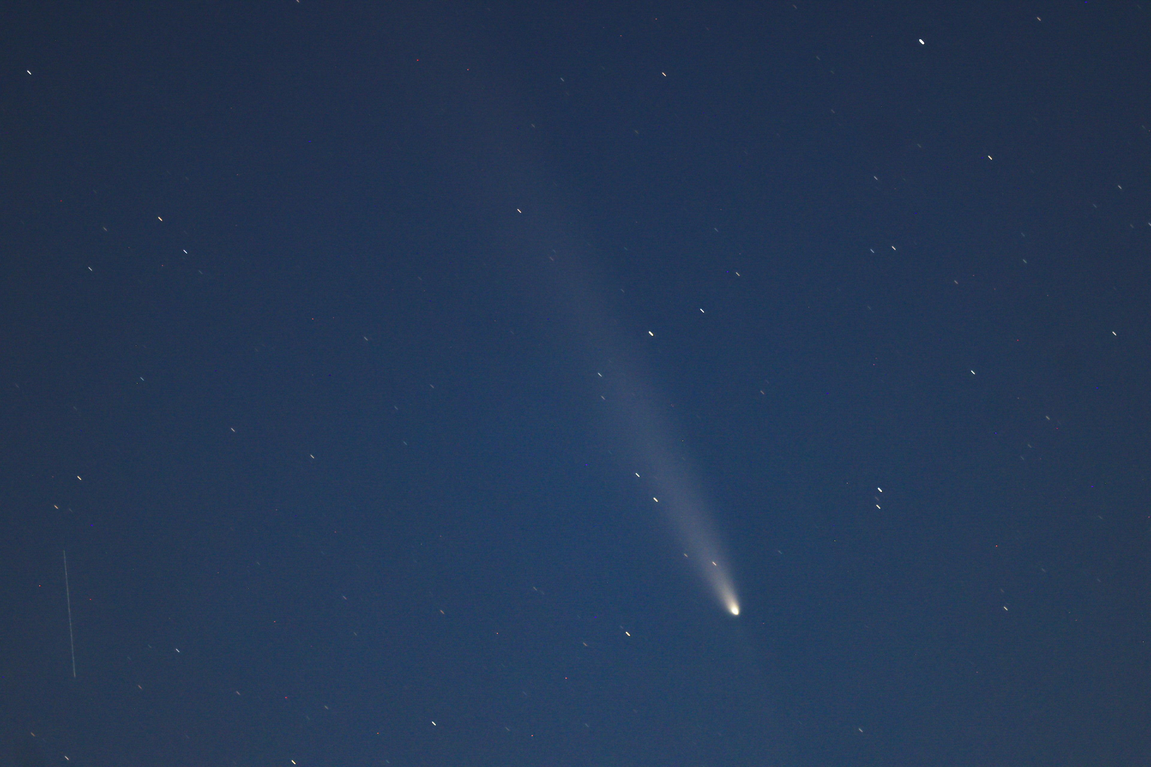 Comet glowing in the night sky with stars