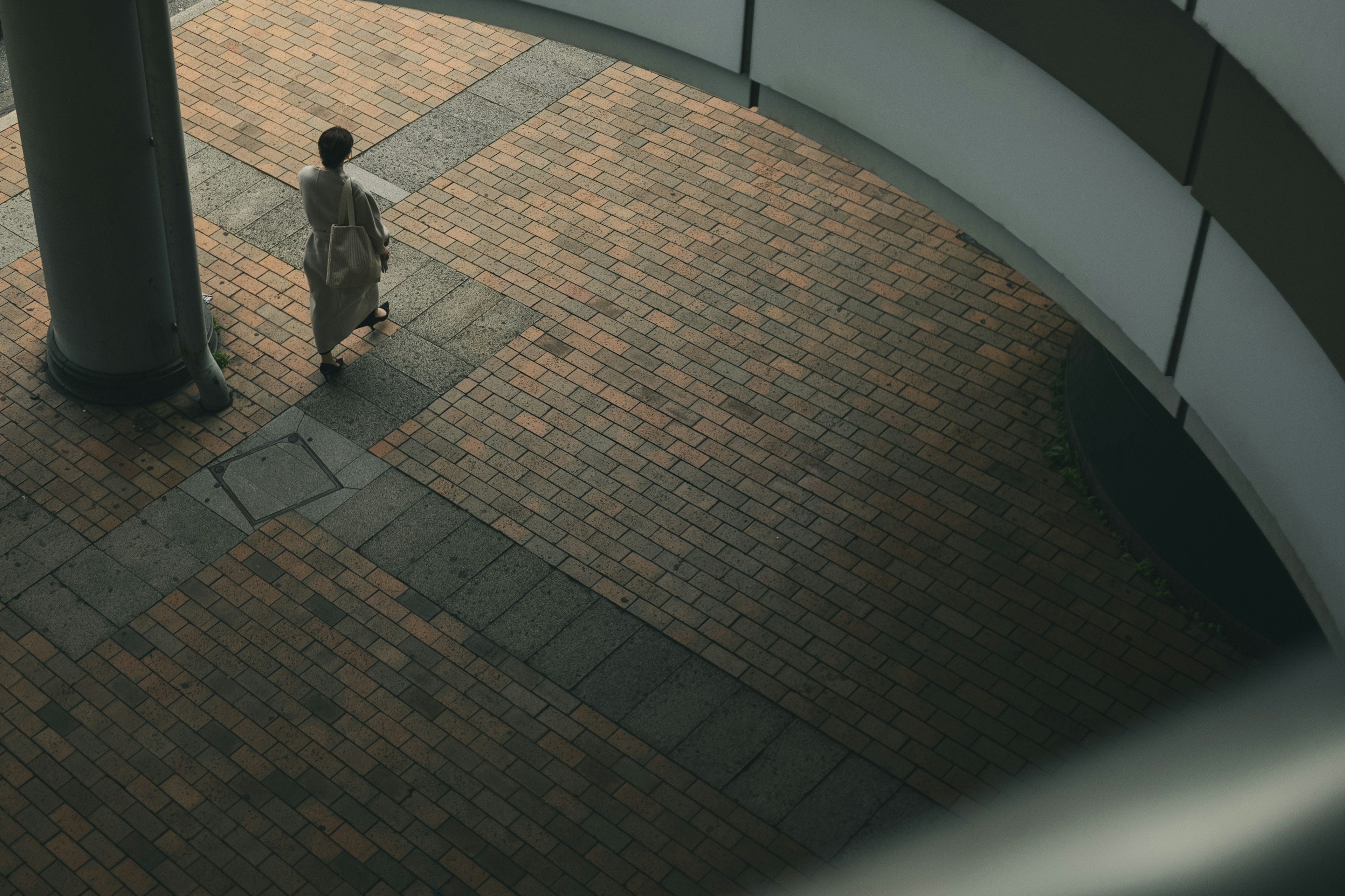 A person walking in a circular building from an overhead perspective