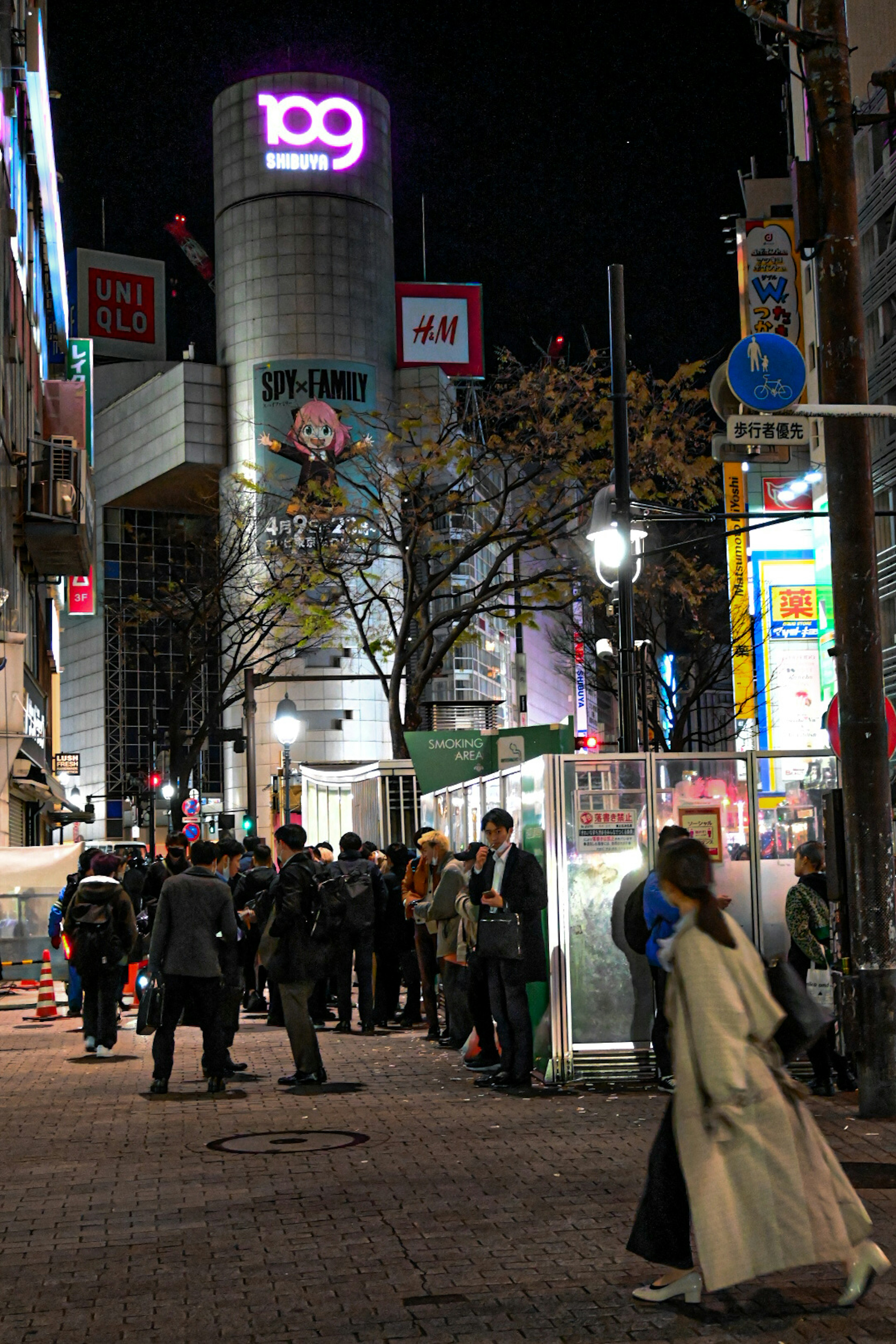 Vista nocturna de las calles de Shibuya con personas en fila