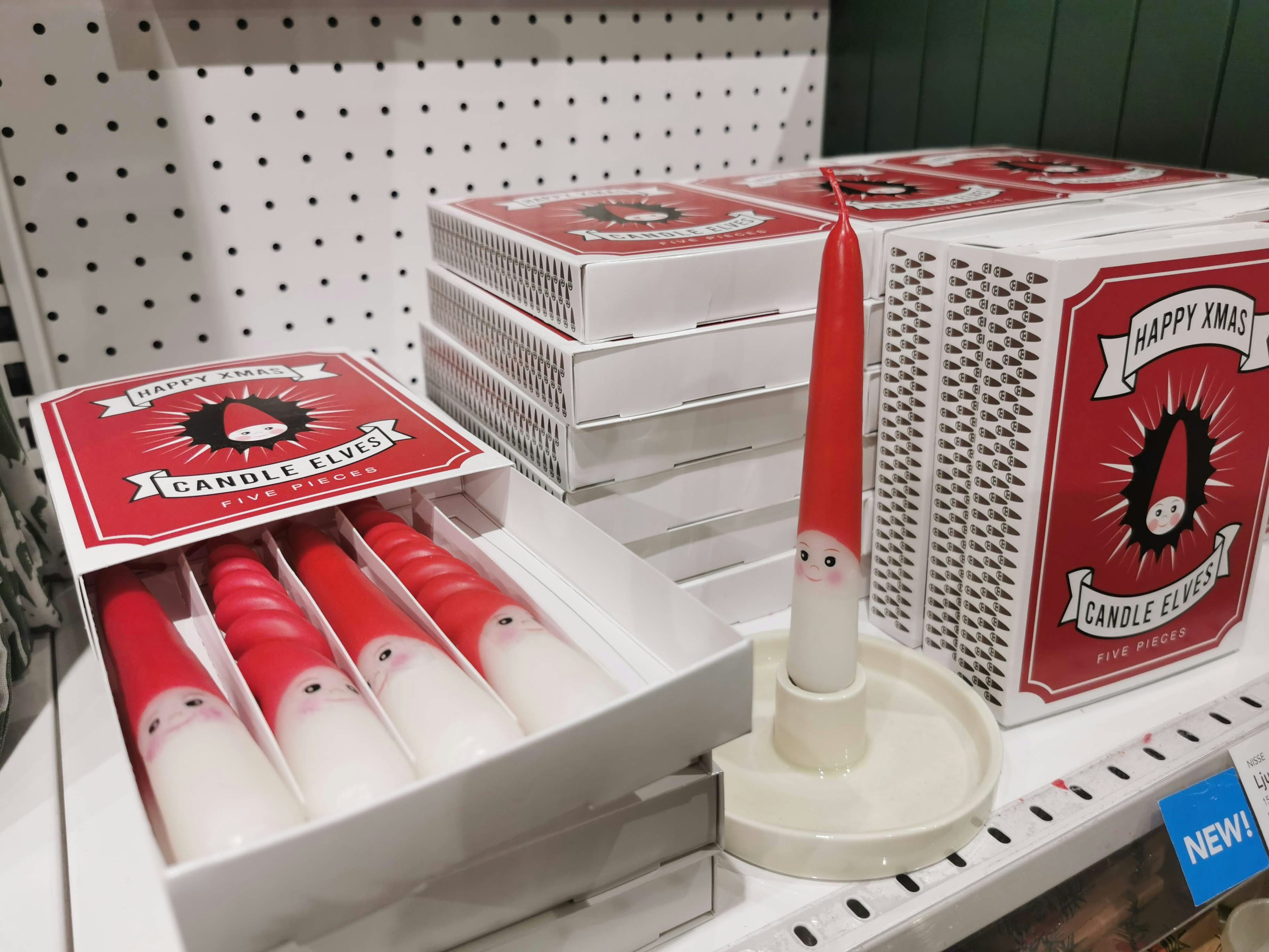 Image of candles with red tips displayed alongside white packaging