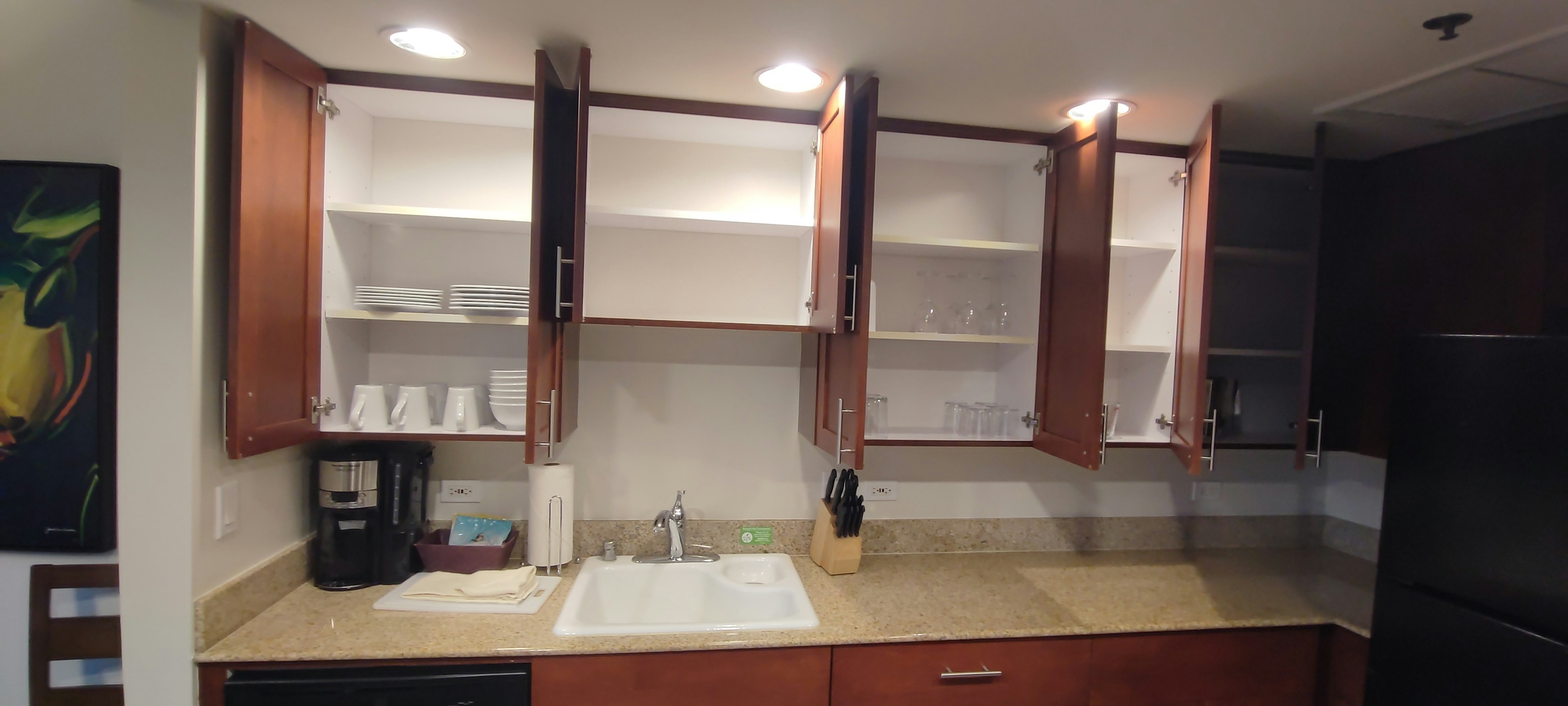 Empty kitchen cabinets with simple countertop and sink