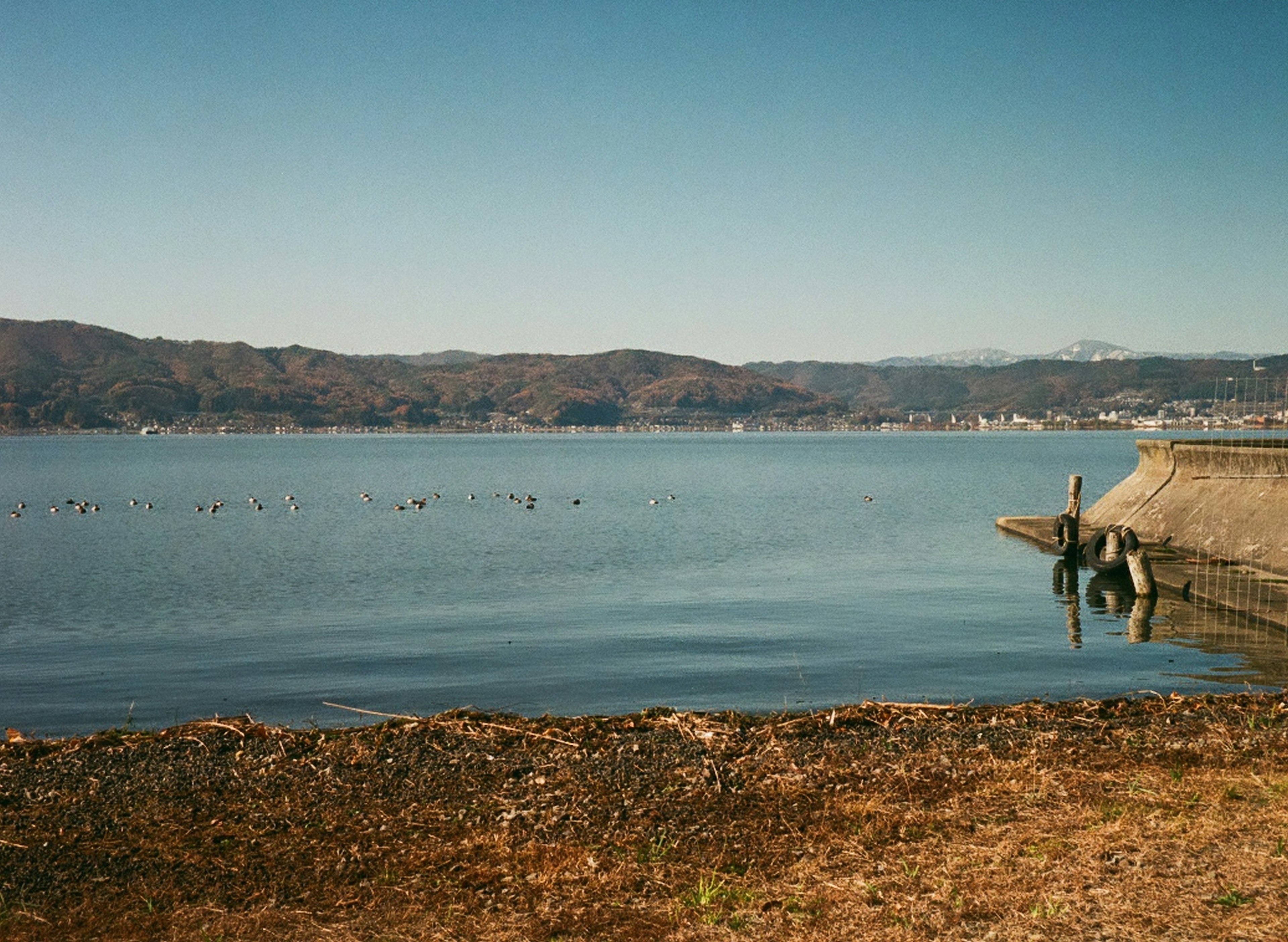 Calm lake with gentle mountains in the background