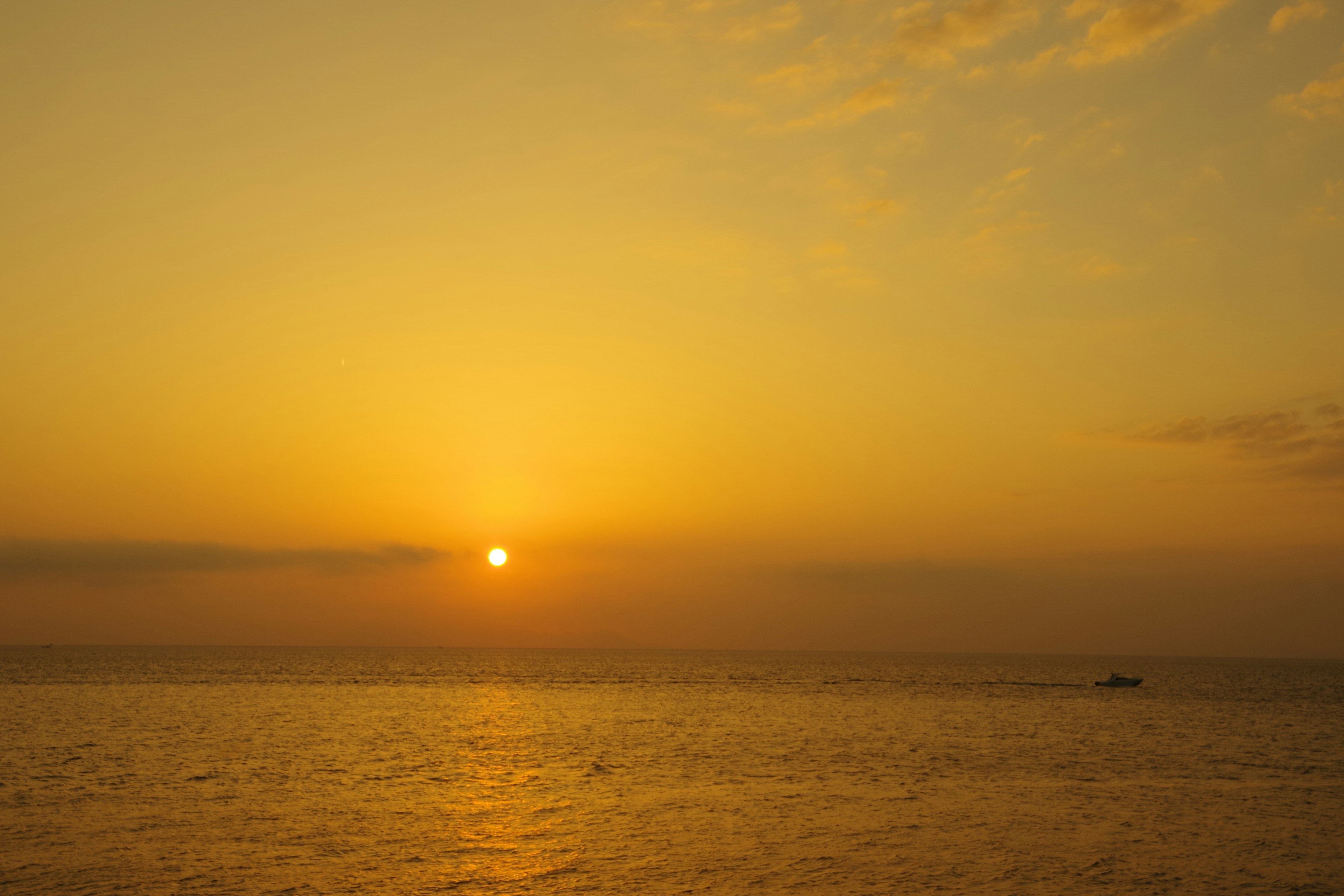 Beautiful twilight scene with the sun setting over the ocean