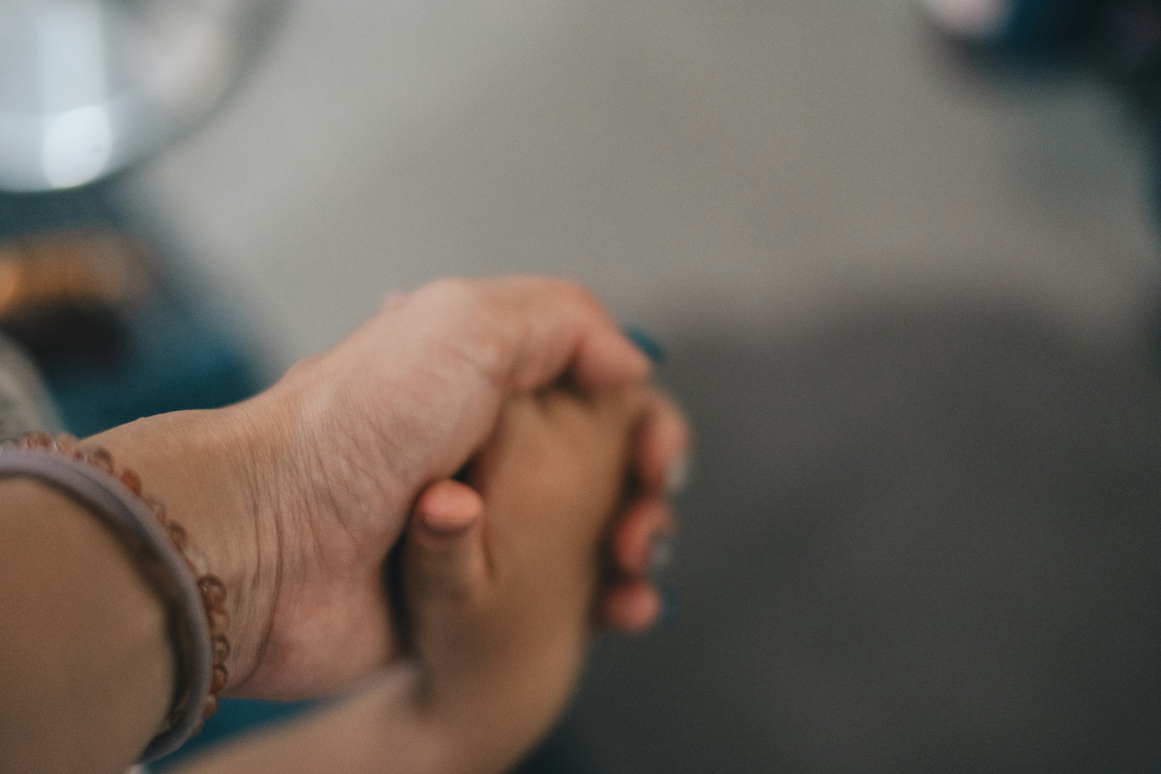 Close-up of two hands holding each other