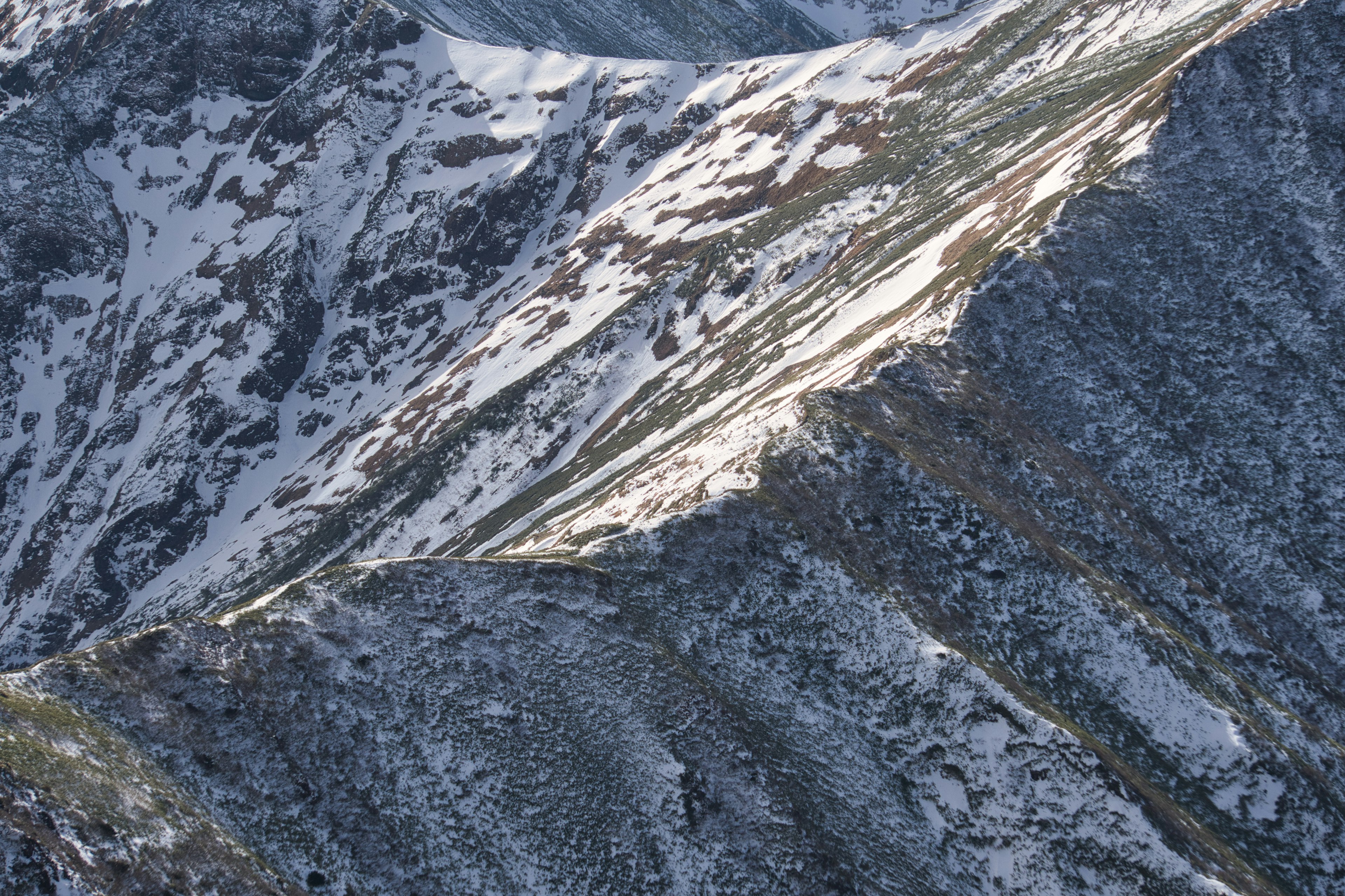 Snow-covered mountain slope with rocky textures