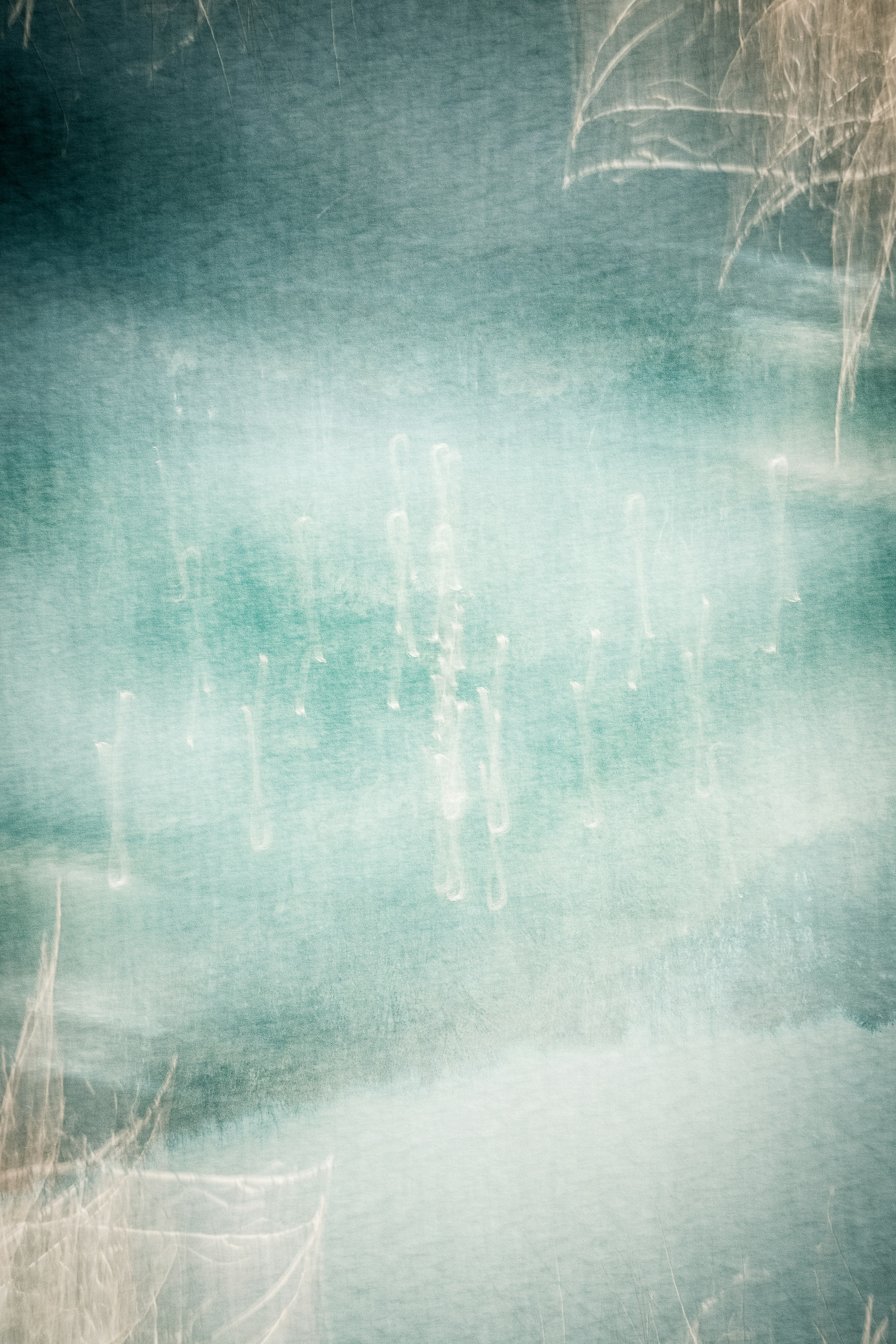 Abstract teal background with blurred reflections of light